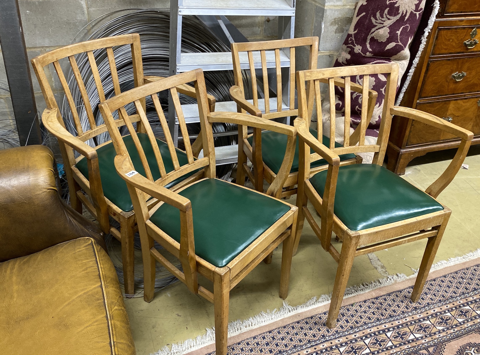 A set of four mid century beech elbow chairs, width 54cm, depth 40cm, height 82cm                                                                                                                                           