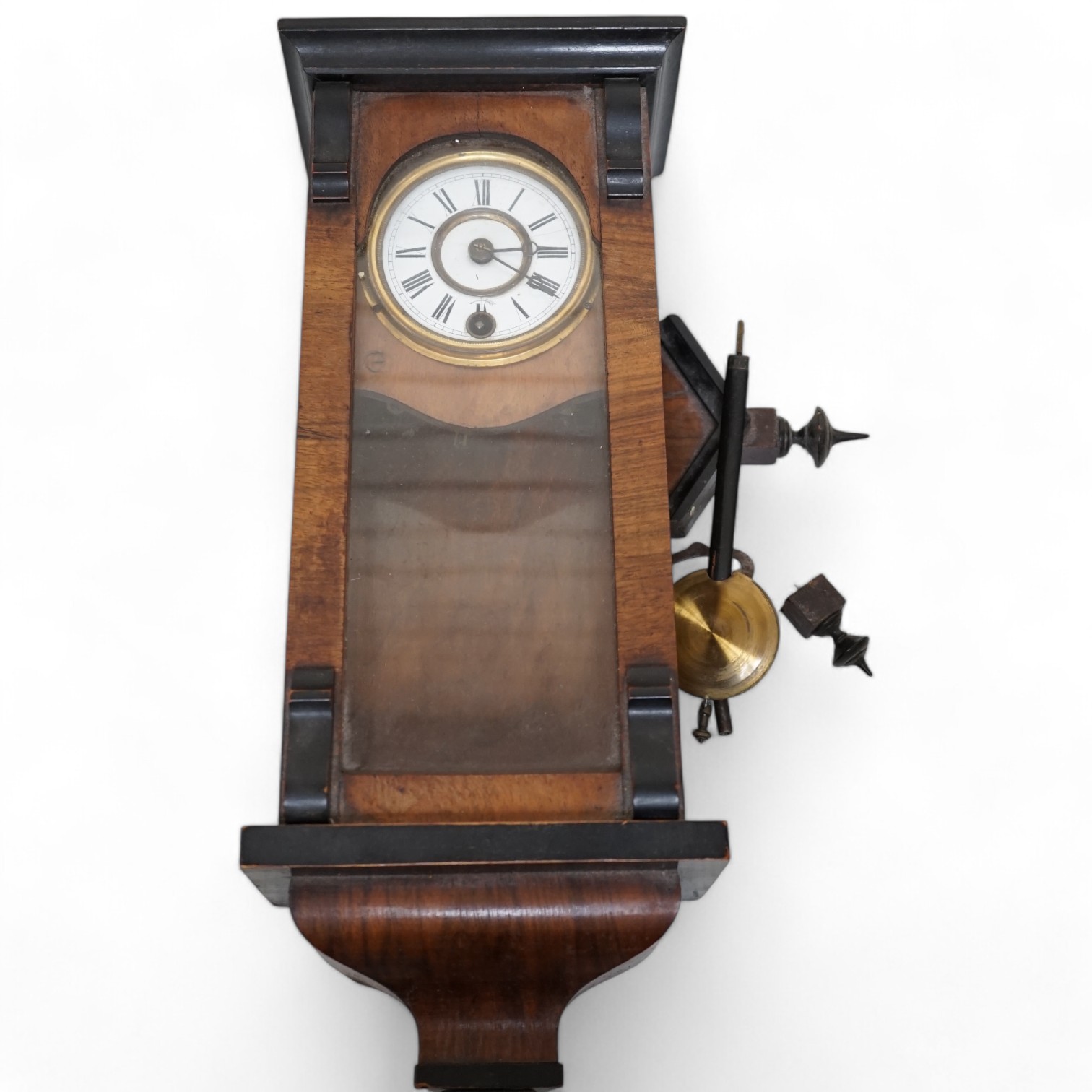 A small walnut cased wall clock with enamel dial with pendulum and key. Condition - poor                                                                                                                                    