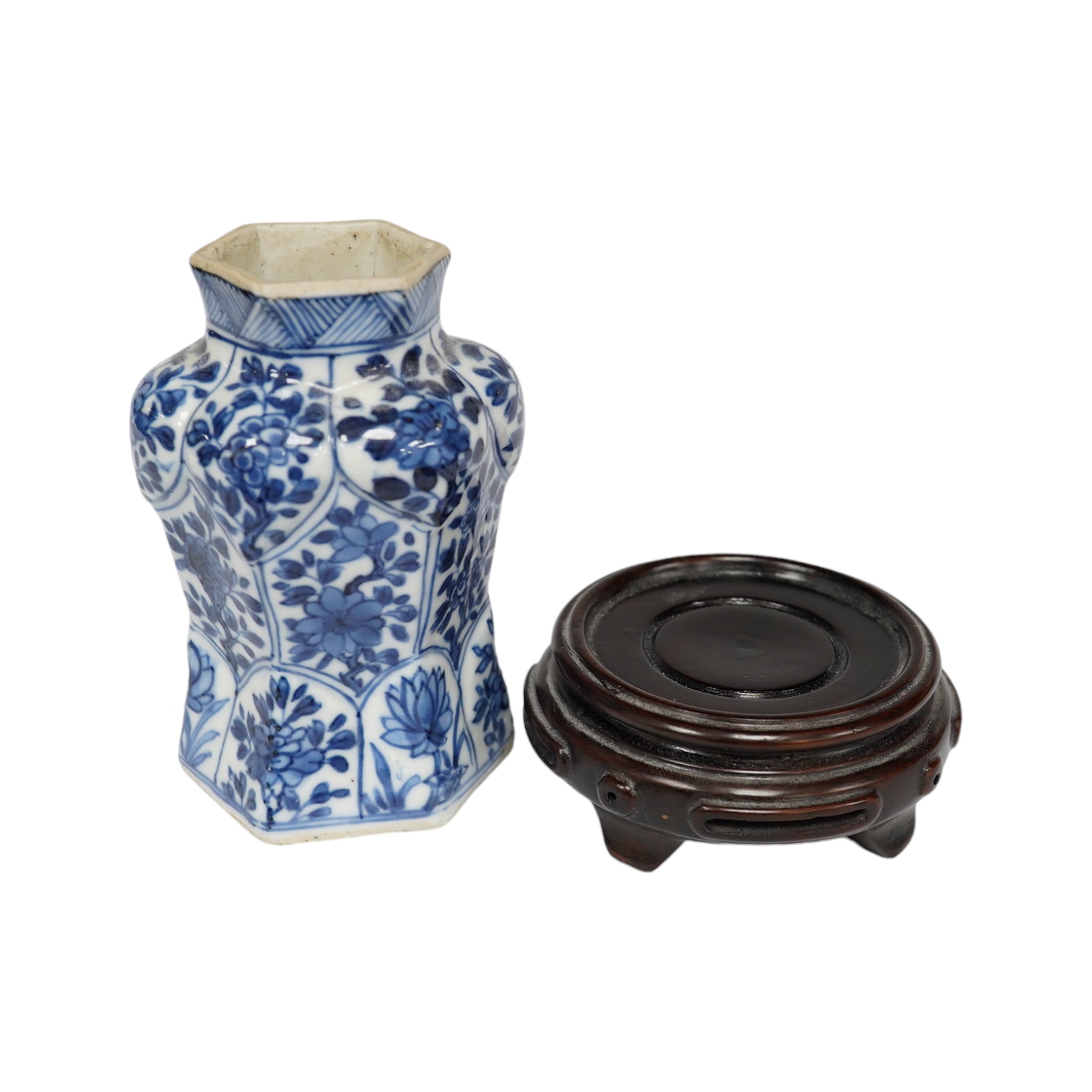 A Chinese blue and white hexagonal jar, Kangxi period and stand, 10cm high. Condition -small firing crack to inside edge of foot, otherwise good                                                                            