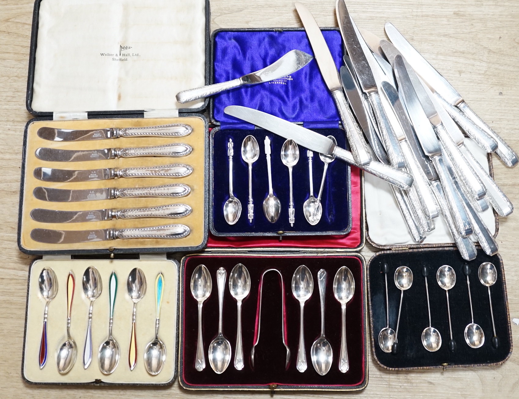 A cased set of six George V silver and polychrome enamel coffee spoons, Barker Brothers Silver Ltd, Birmingham, 1932, four other cased sets including teaspoons and tea knives and seventeen assorted Towle sterling handled