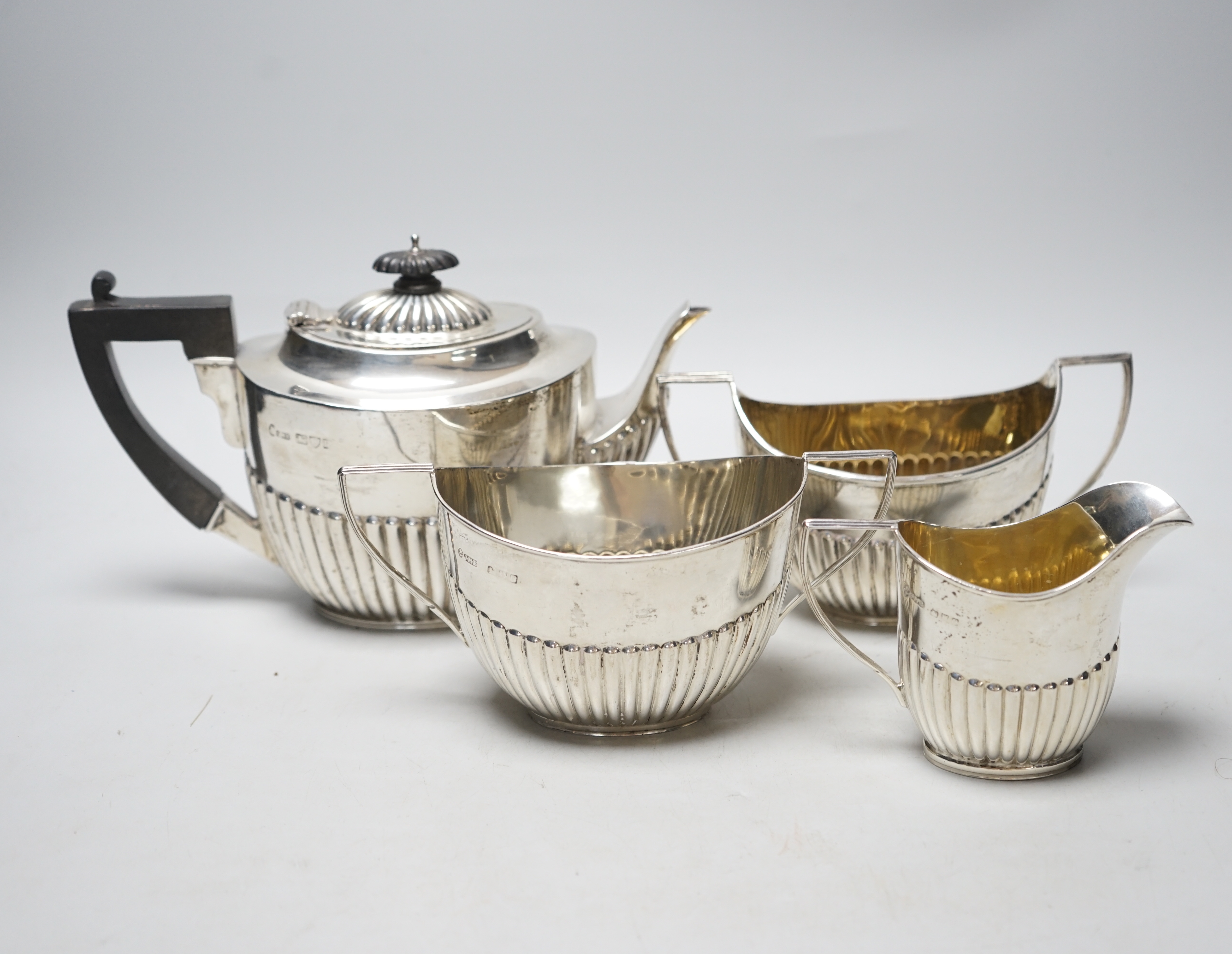 A late Victorian demi-fluted silver three piece tea set, John Milward Banks, Chester, 1898/1900 and one other similar silver sugar bowl, gross weight 26.8oz.                                                               