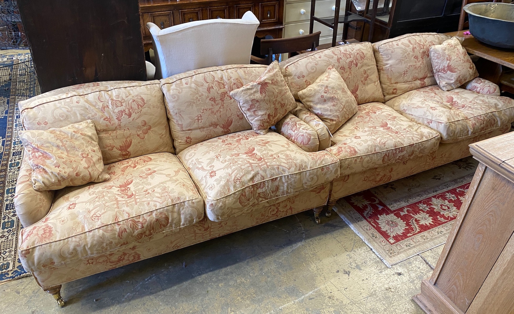A pair of John Sankey two seater settees with feather cushion seats and backs, length 156cm, depth 82cm, height 75cm                                                                                                        