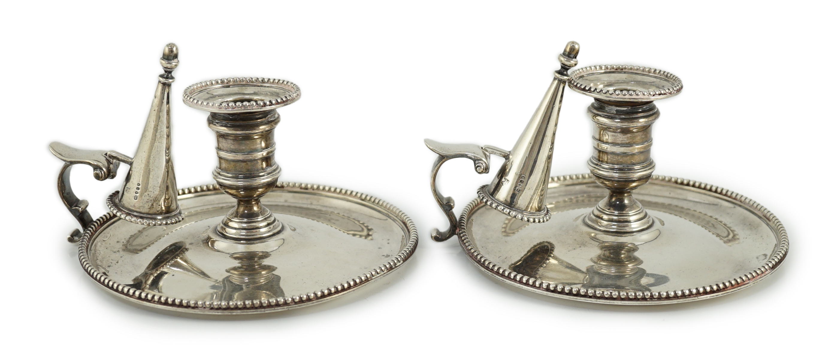 A pair of Victorian silver chambersticks and extinguishers, by Charles Thomas Fox and George Fox                                                                                                                            