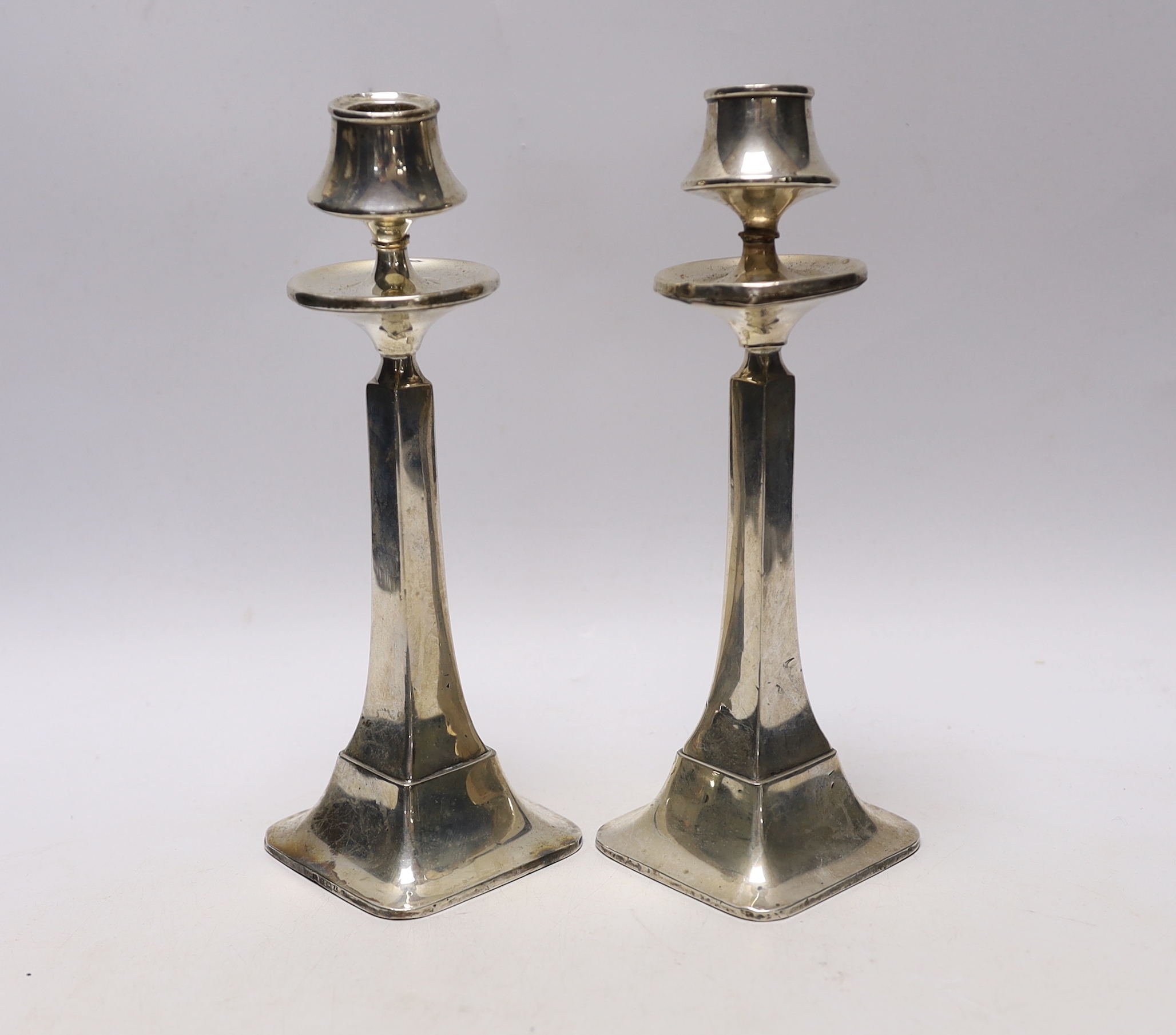 A pair of George V silver candlesticks, of tapering form, Charles S. Green & Co, Birmingham, 1924/25, height 22.5cm, weighted, (a.f.)                                                                                       