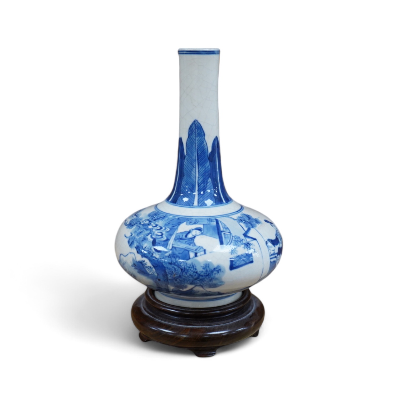 A 19th century Chinese blue and white crackle glaze bottle vase on hardwood stand, 20cm total. Condition - firing cracks to neck interior                                                                                   
