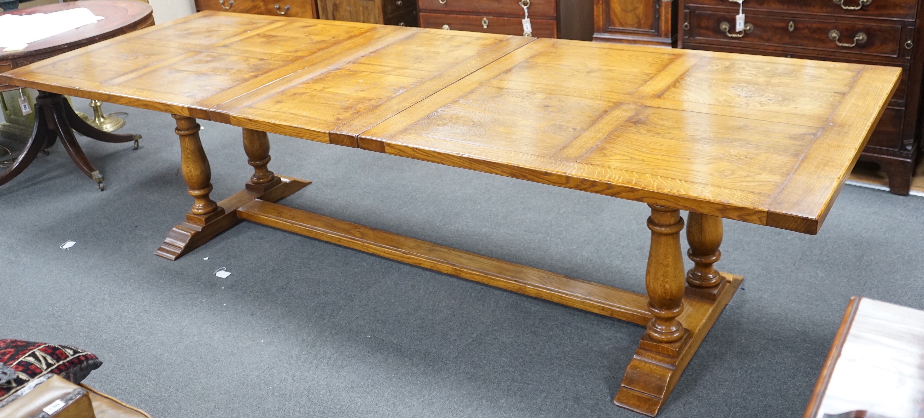 A reproduction 18th century style oak extending refectory dining table, length 306cm extended, one spare leaf, width 106cm, height 75cm                                                                                     