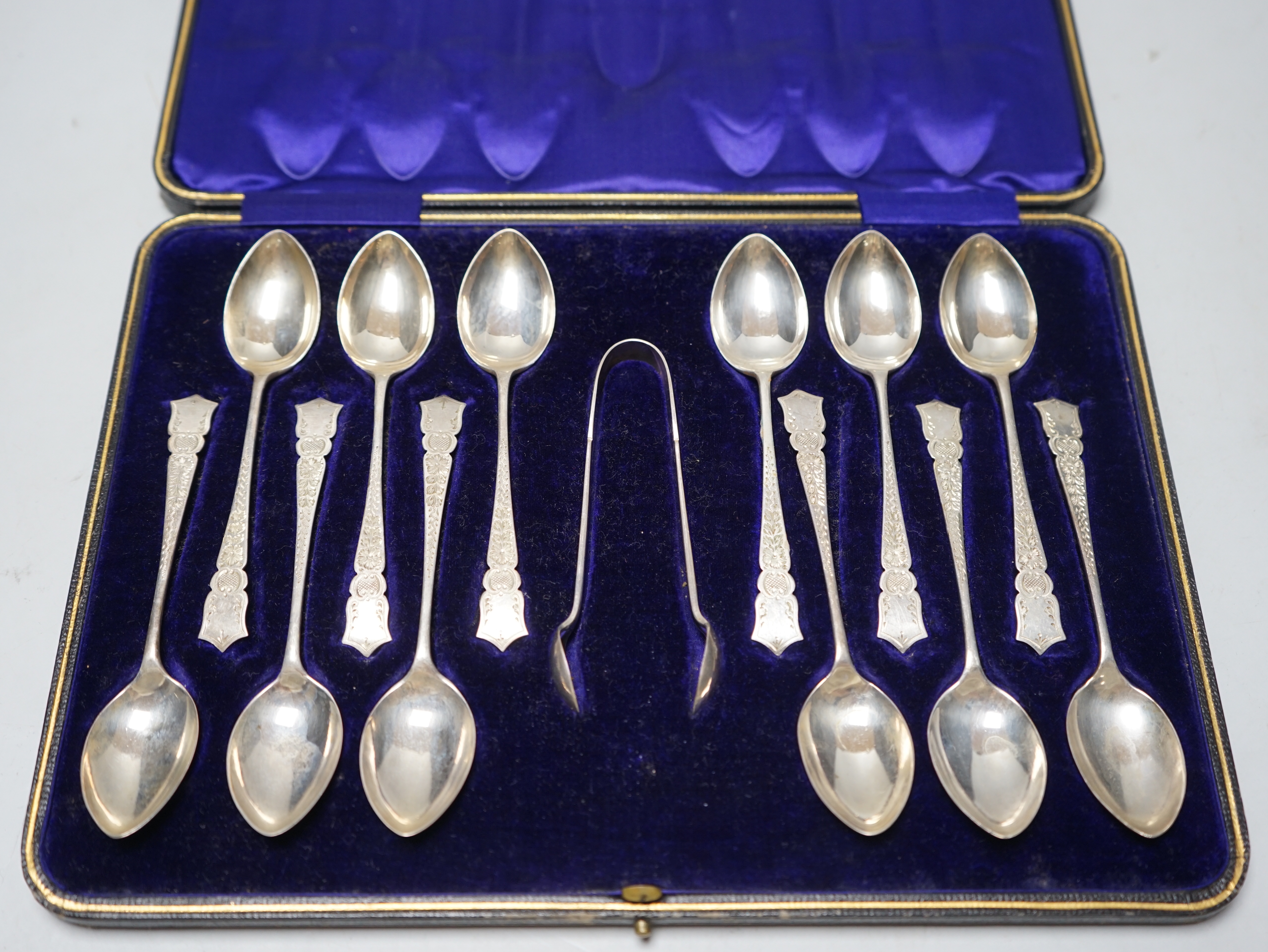 A cased set of twelve pierced silver teaspoons and tongs, John Sanderson, Sheffield, 1907.                                                                                                                                  