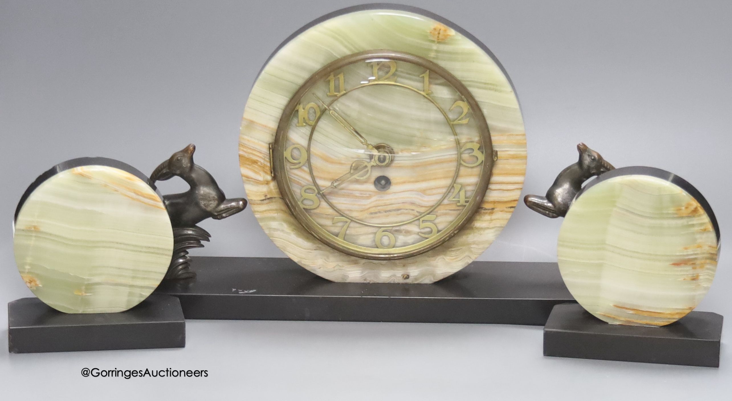 An Art Deco slate and onyx 'antelope' clock garniture, length of central piece 44cm                                                                                                                                         