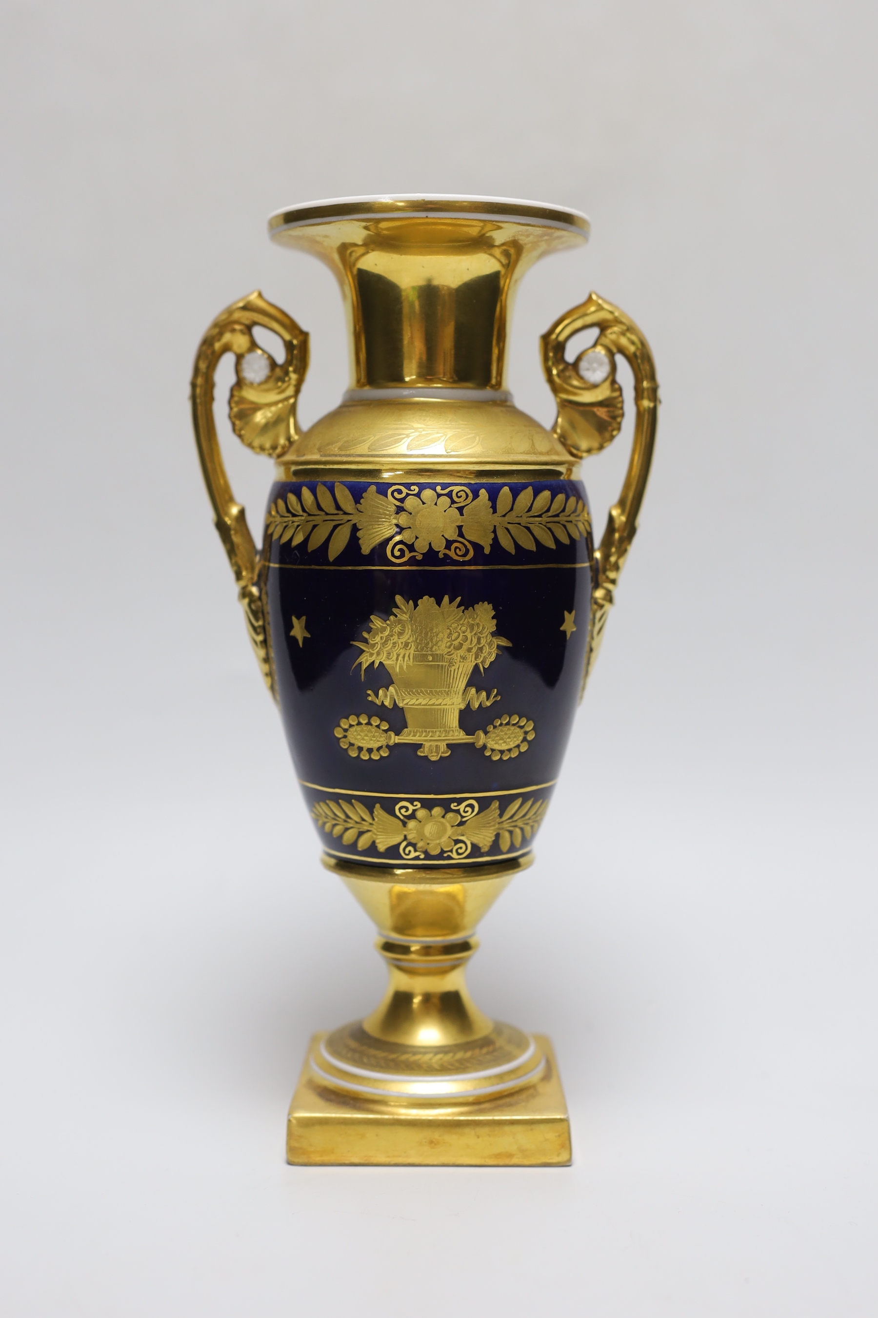 A fine Paris porcelain vase with two handles, highly gilded, the blue ground with a basket of flowers on each side, 23.5cm tall                                                                                             