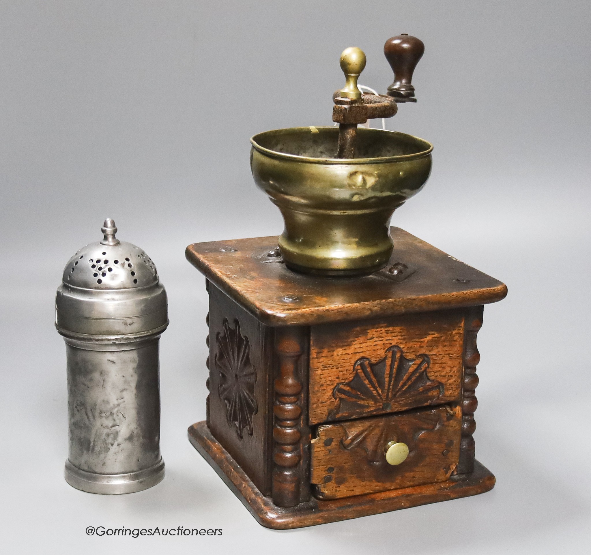 An 18th century oak and brass coffee grinder and a pewter muffineer                                                                                                                                                         