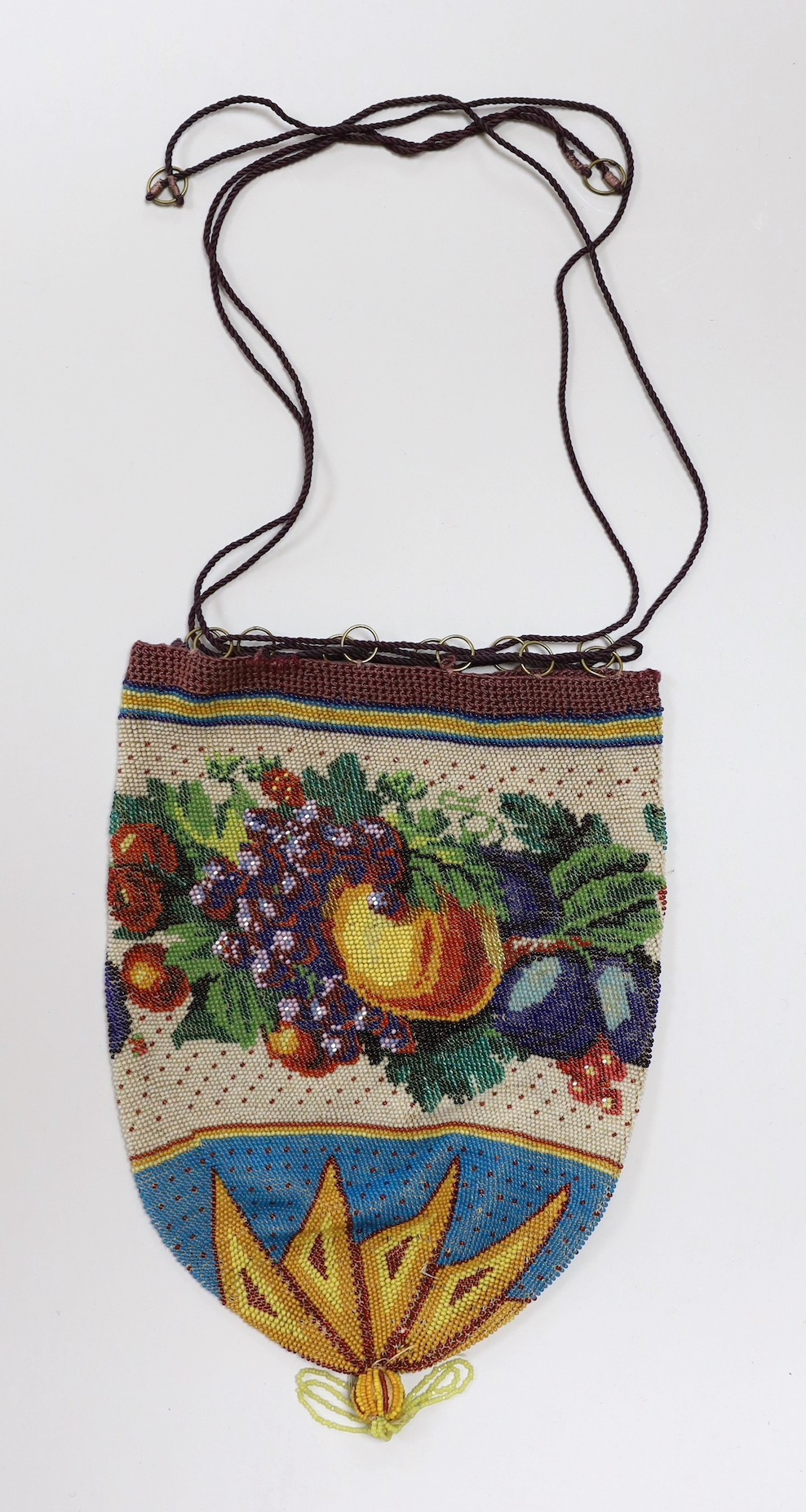 An unusual finely beaded early 19th century draw string bag, decorated with a wide band of multi coloured fruits and leaves.                                                                                                