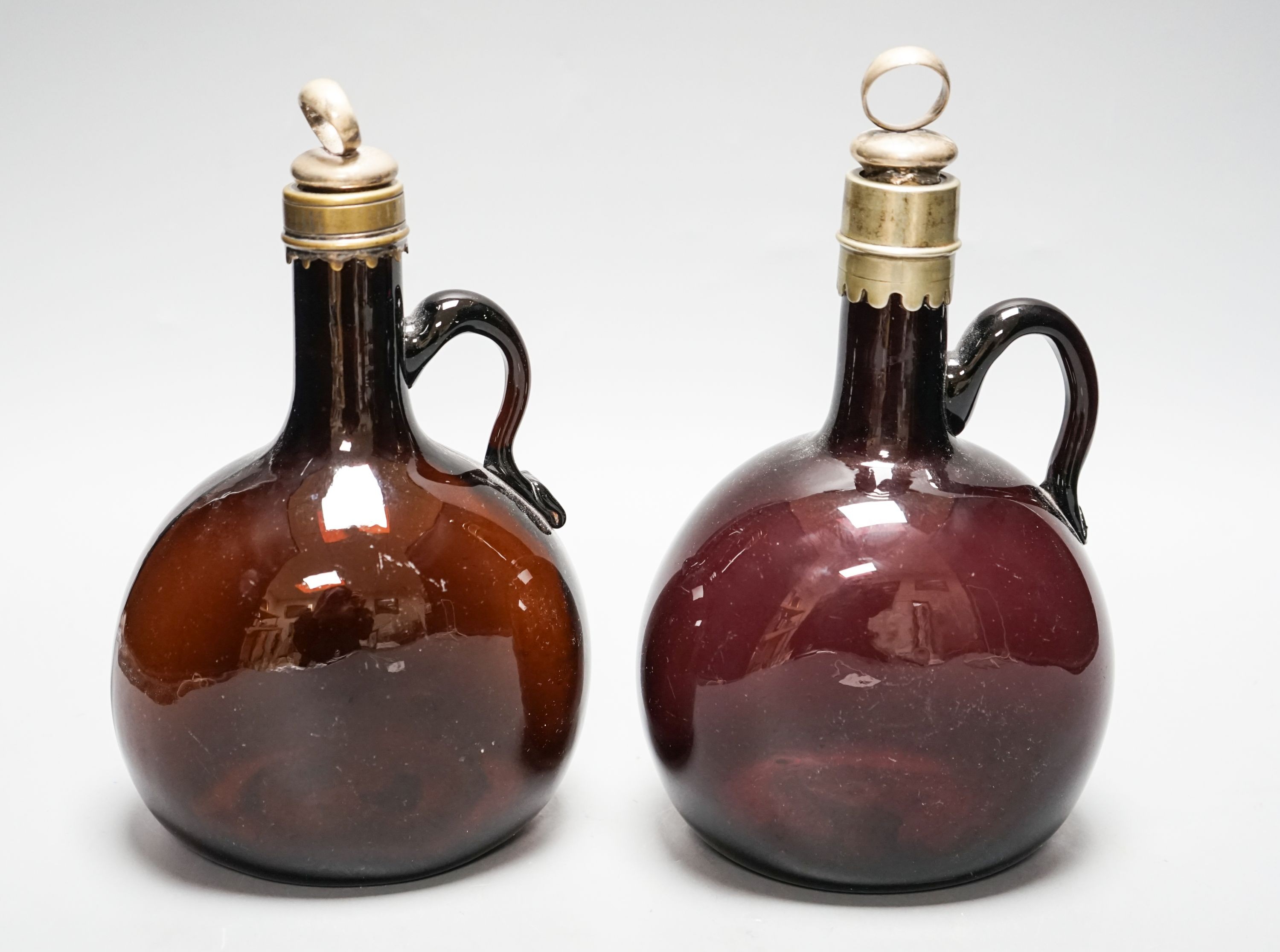 A Victorian amethyst glass claret and amber hock jugs, 23cm                                                                                                                                                                 