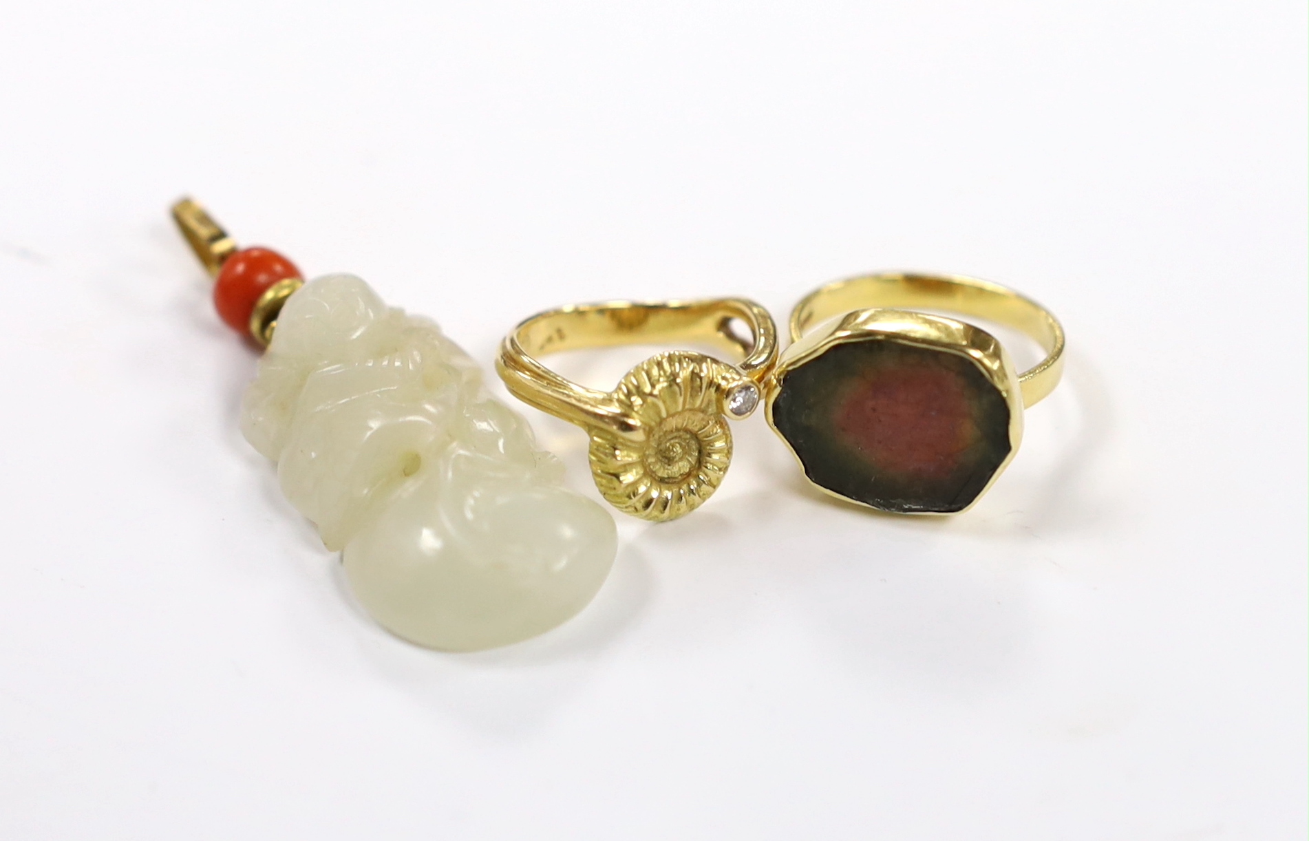 A yellow metal and coral bead mounted carved jade pendant, overall 49mm, a 1970's 18ct gold and tourmaline? set modernist ring, maker, GR and a 750 yellow metal and diamond set urchin ring, maker LH, gross weight 13.5 gr