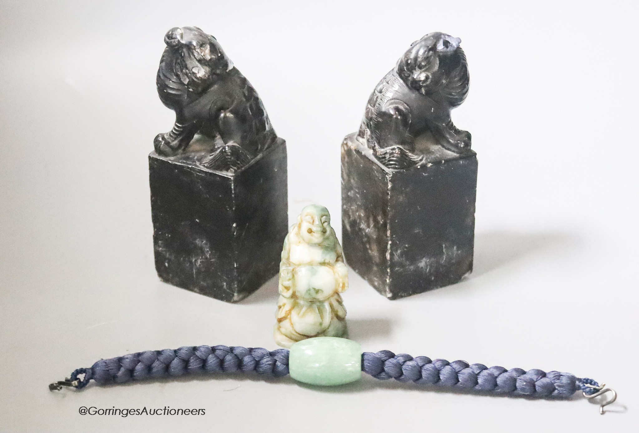 A pair of hardstone carved Temple dogs, height 13cm, a Buddha and a jade bead bracelet                                                                                                                                      