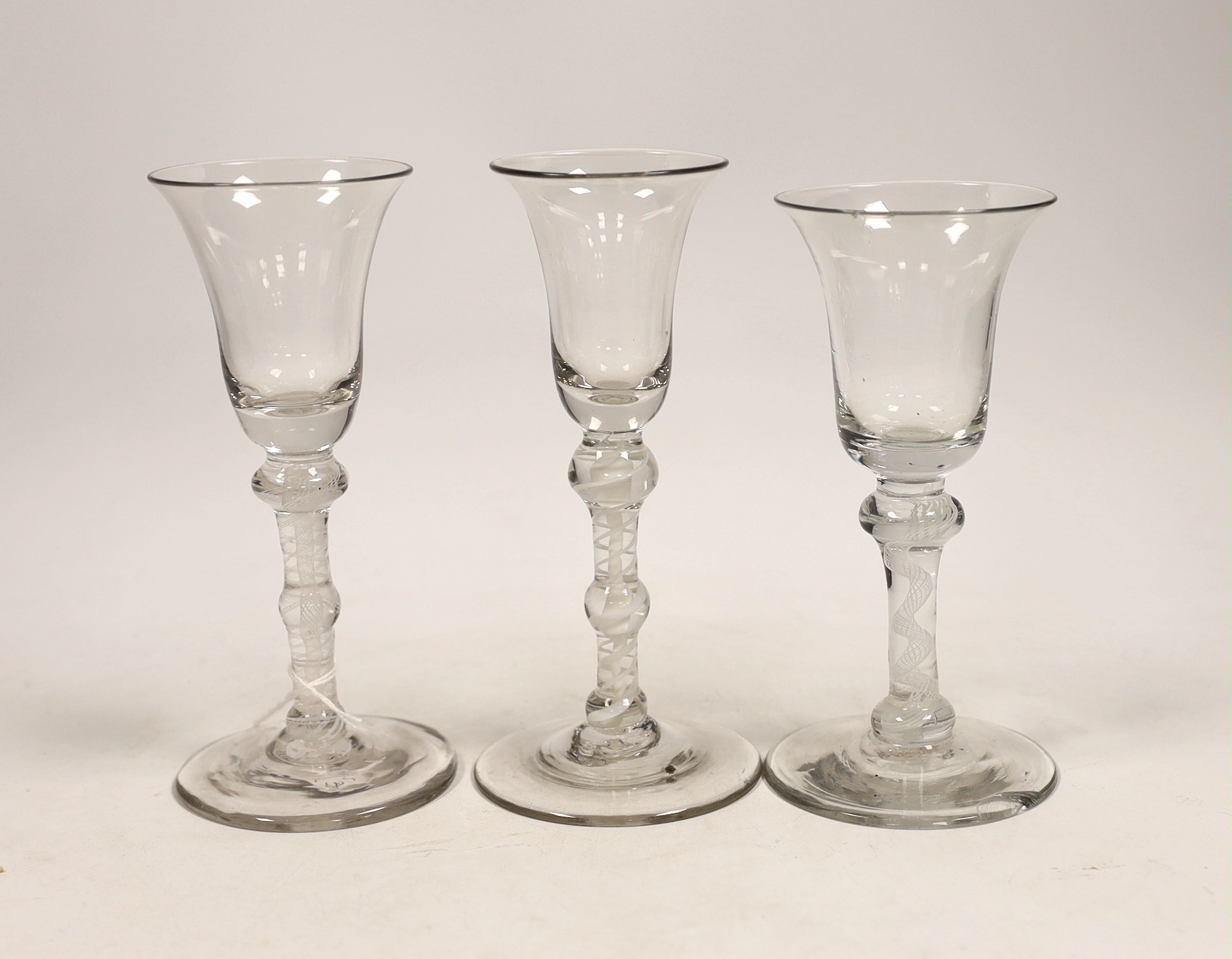 Three George III DSOT stem wine glasses, c.1760, largest 17cm high                                                                                                                                                          