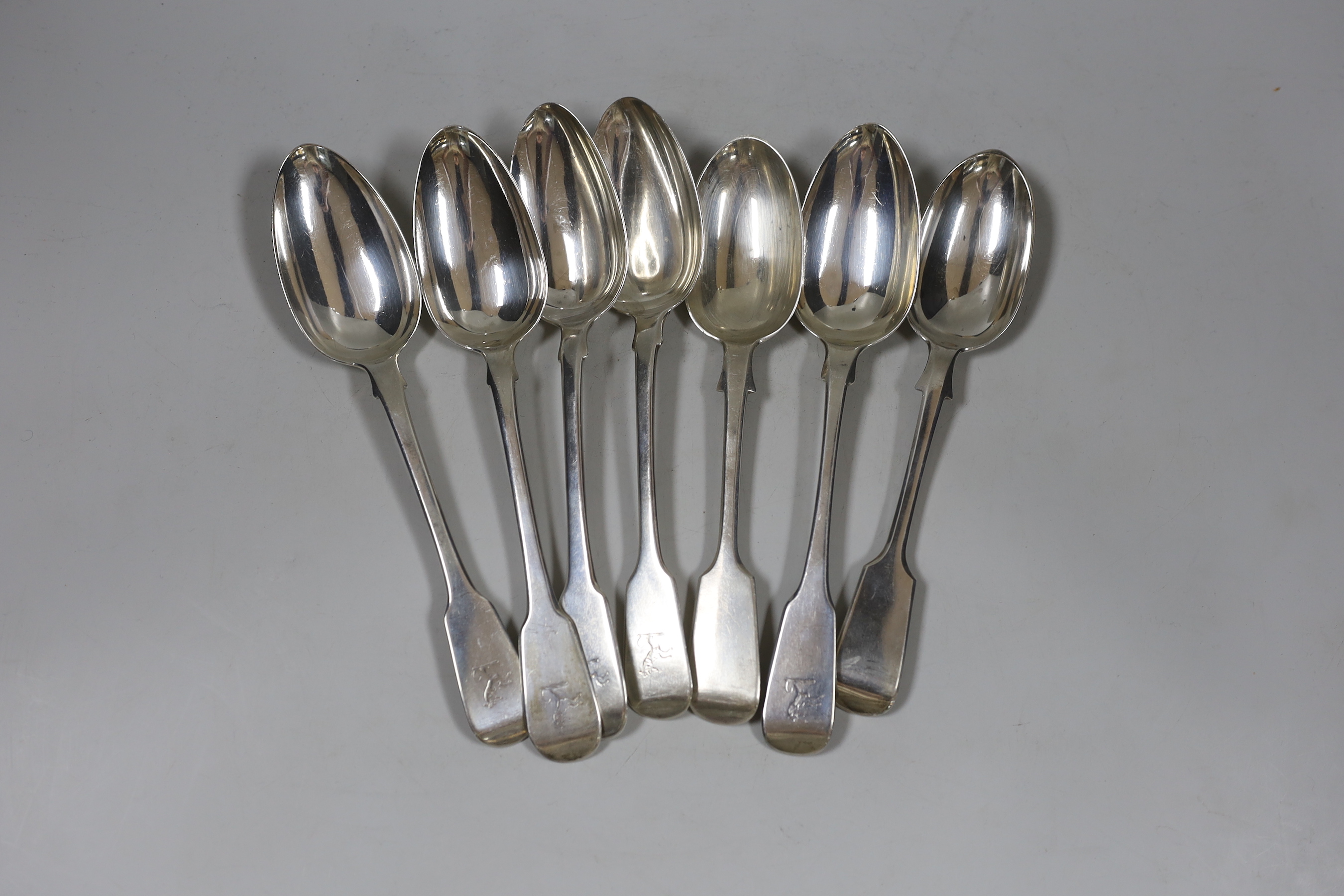 A harlequin set of seven George III and later silver fiddle pattern table spoons, various dates and makers, 16.1oz.                                                                                                         