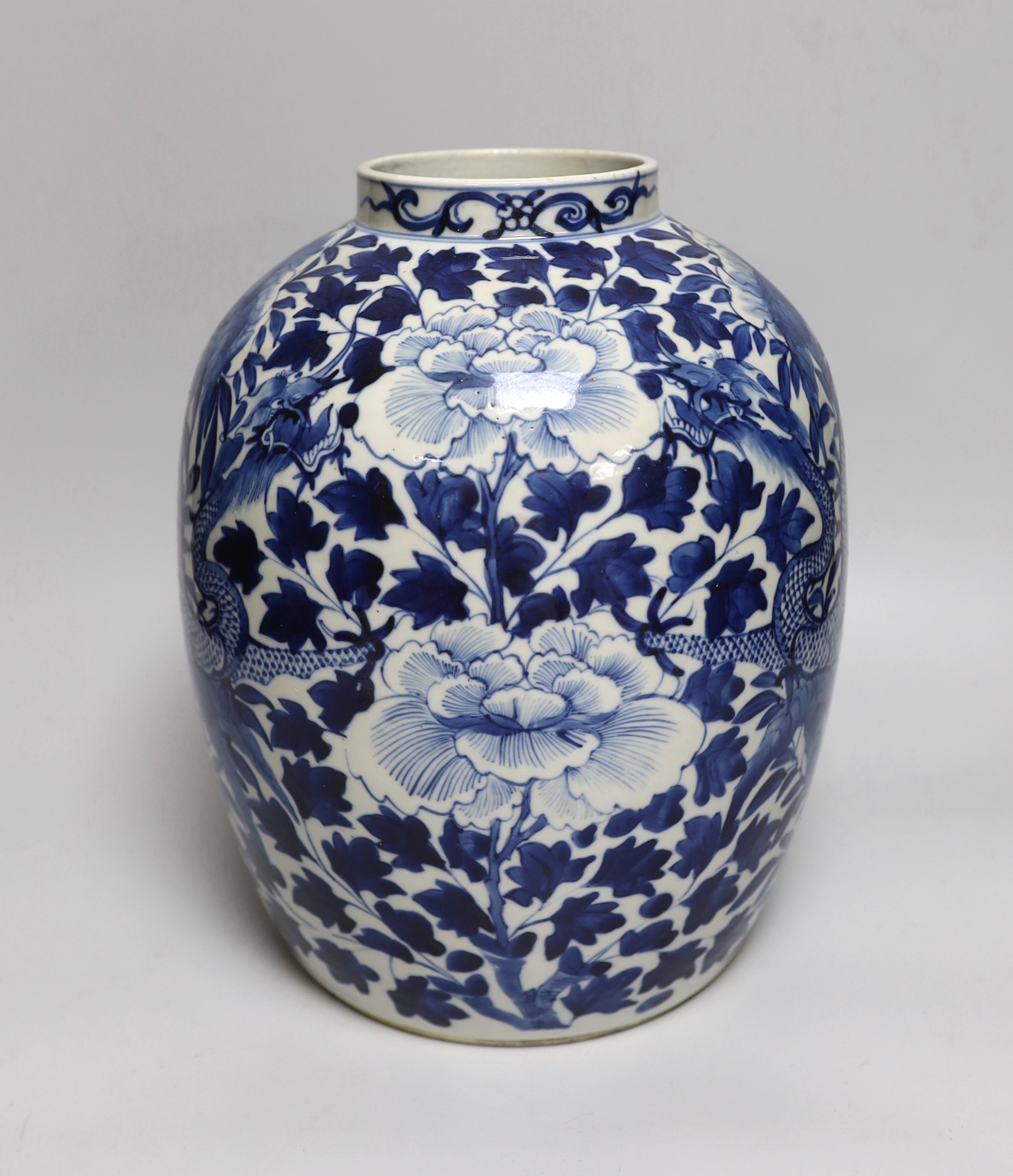 A large Chinese blue and white jar painted with a dragon amongst leaves and flowers, 29cm high                                                                                                                              