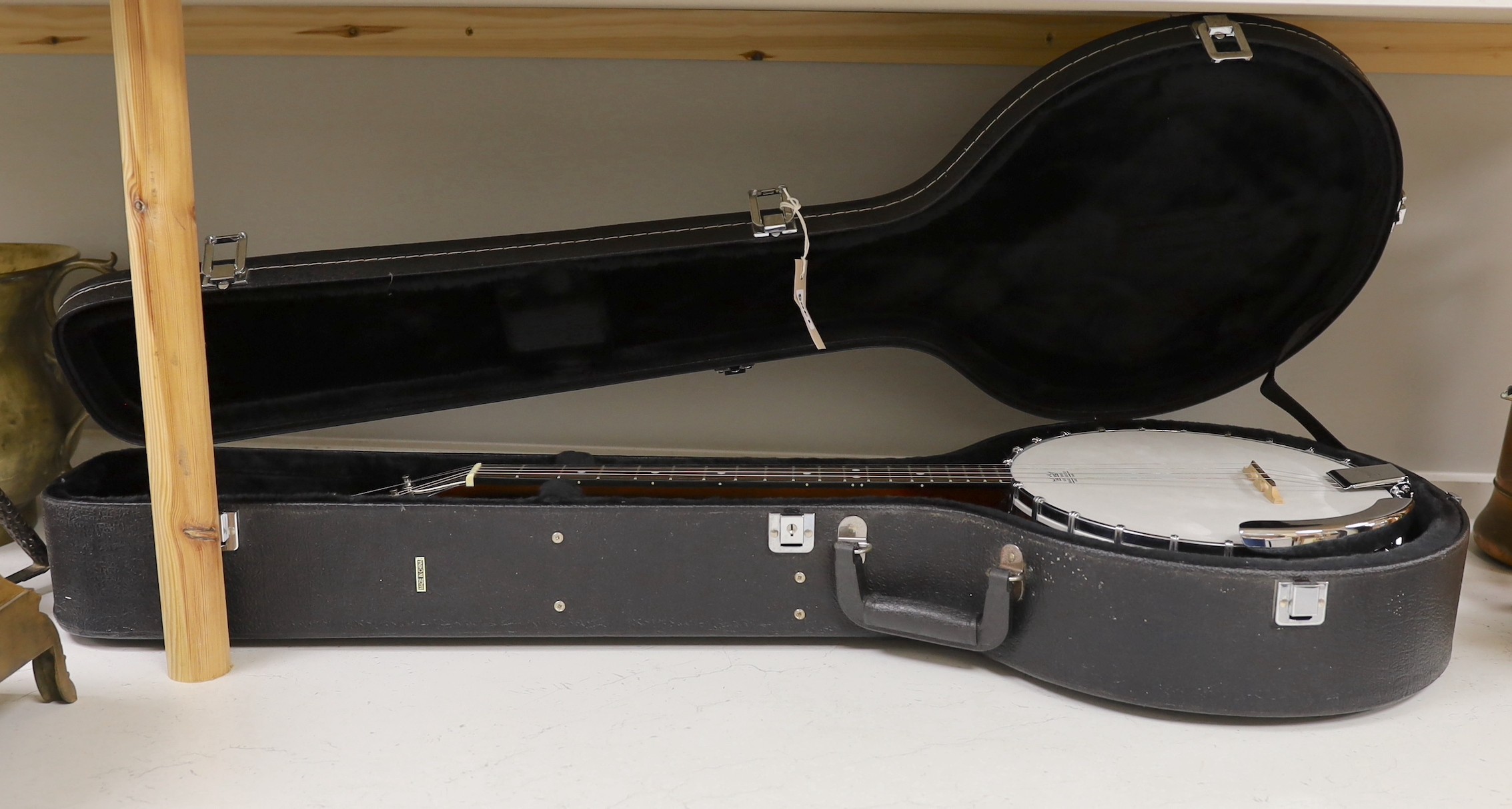 An Ozark banjo in a hard case                                                                                                                                                                                               