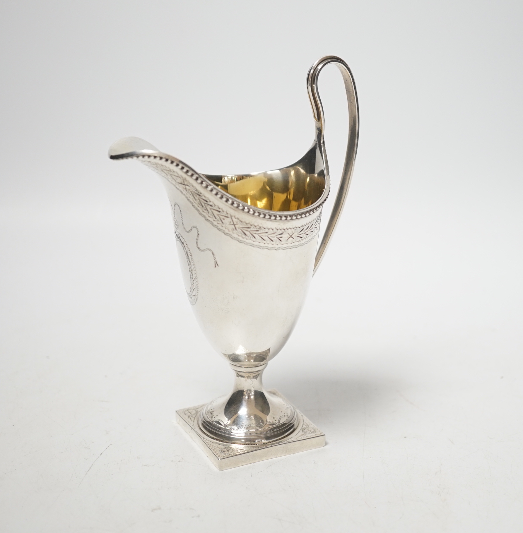 A modern George III style helmet shaped cream jug, on square base, C.J. Vander Ltd, London, 1972, 16.3cm, 4.4oz.                                                                                                            