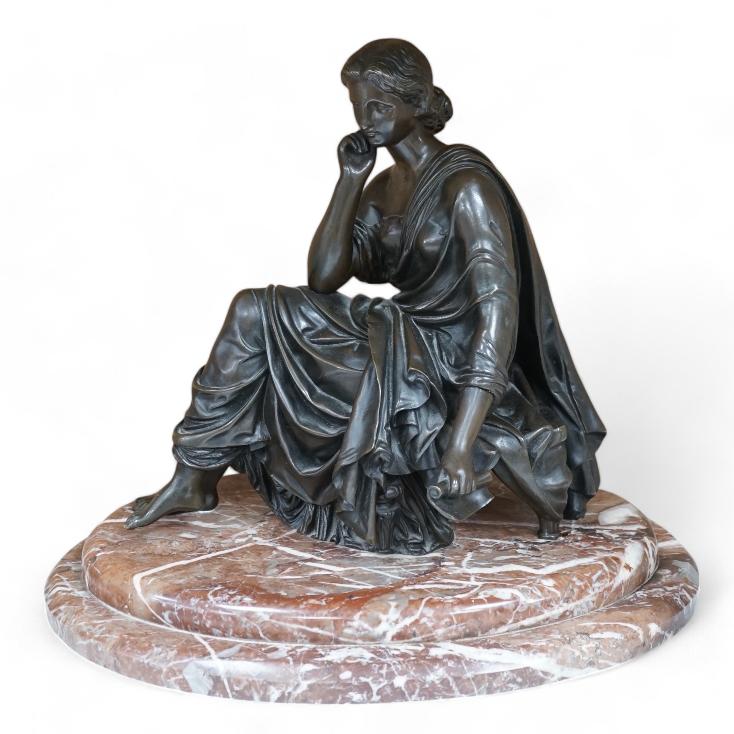 A Continental bronze of a seated young woman on a rouge marble base 37cm wide. Condition - good                                                                                                                             