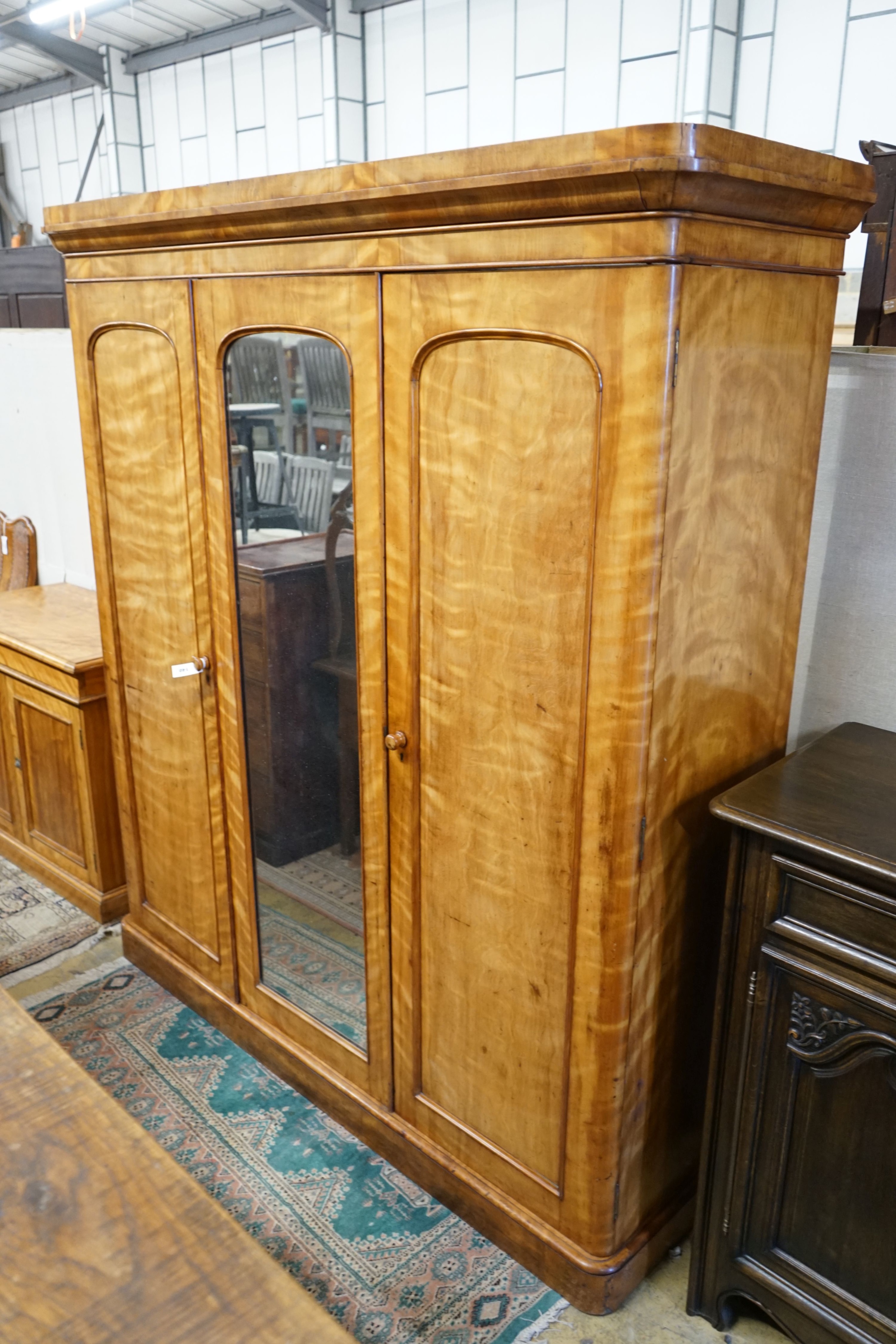 A Victorian satin birch mirrored door triple wardrobe, length 180cm, depth 58cm, height 209cm                                                                                                                               