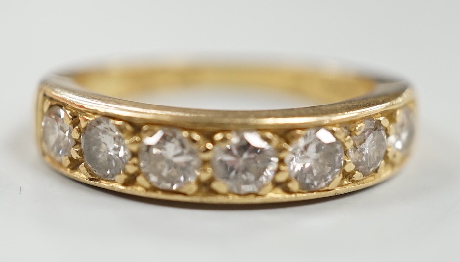 A modern 18ct gold and seven stone diamond set half hoop ring, size P, gross weight 5.3 grams.                                                                                                                              
