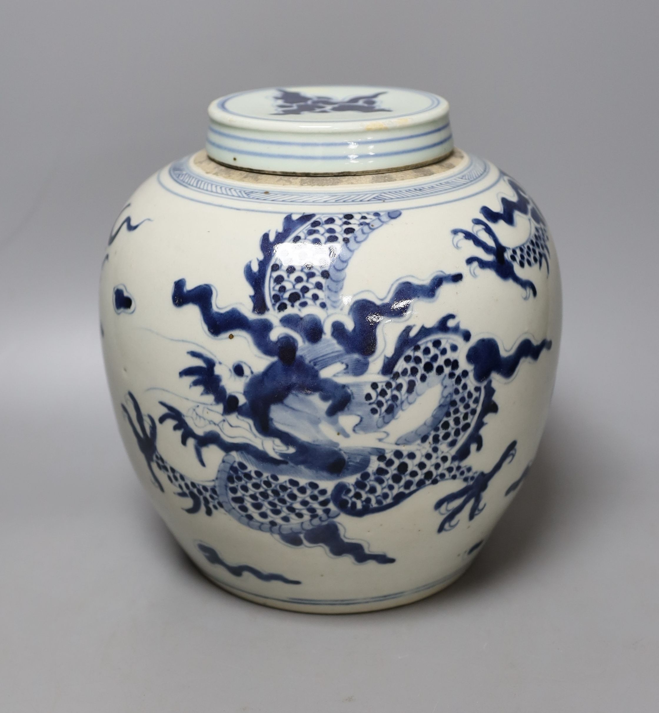 A Chinese blue and white ‘dragon’ jar and associated cover, collectors mark to shoulder. 22cm                                                                                                                               