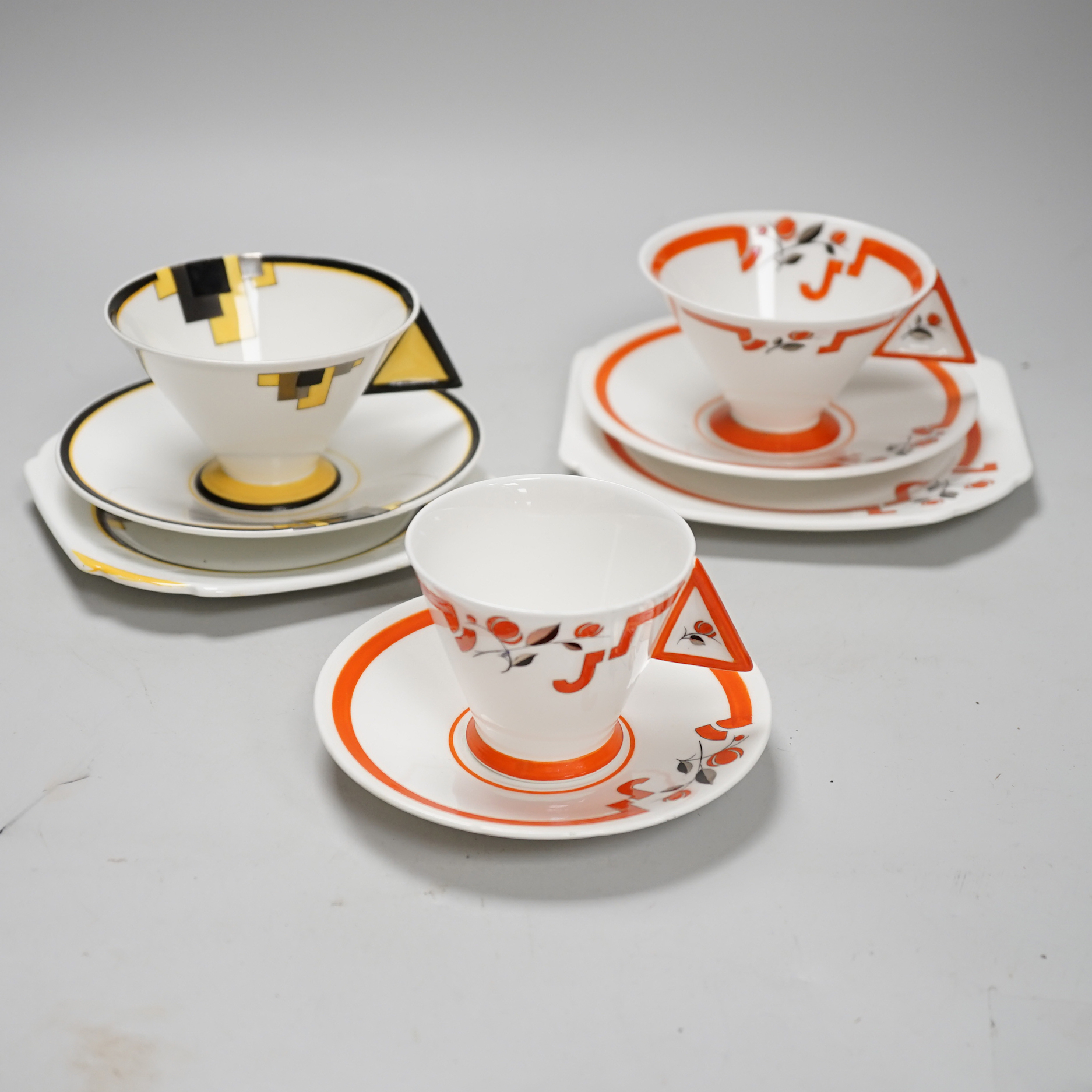 Two Art Deco Shelley Vogue shaped handled trios and a cup and saucer, largest cups 6.5cm high                                                                                                                               