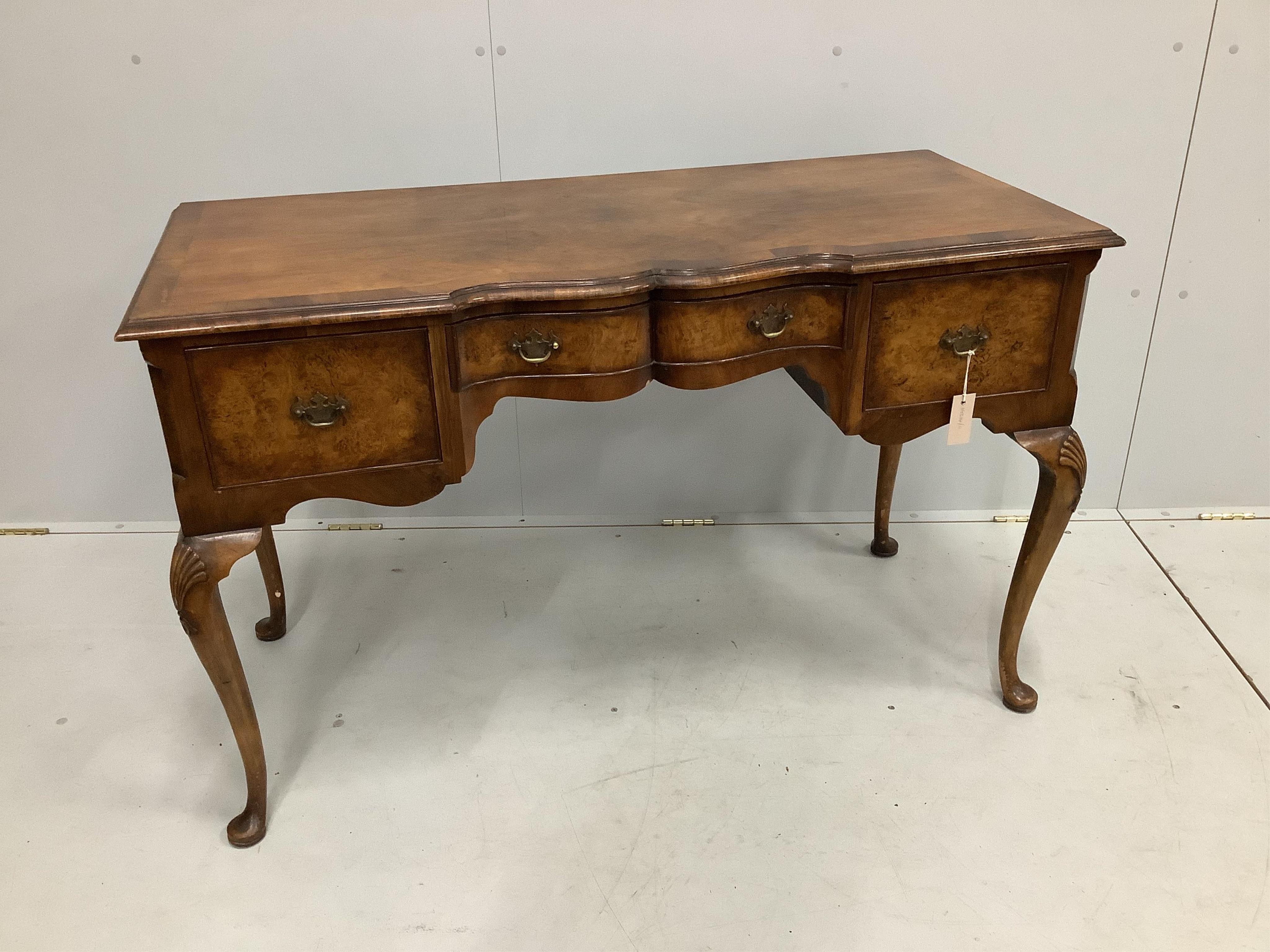 An early 20th century Queen Anne Revival burr walnut kneehole dressing table, width 120cm, depth 52cm, height 75cm                                                                                                          