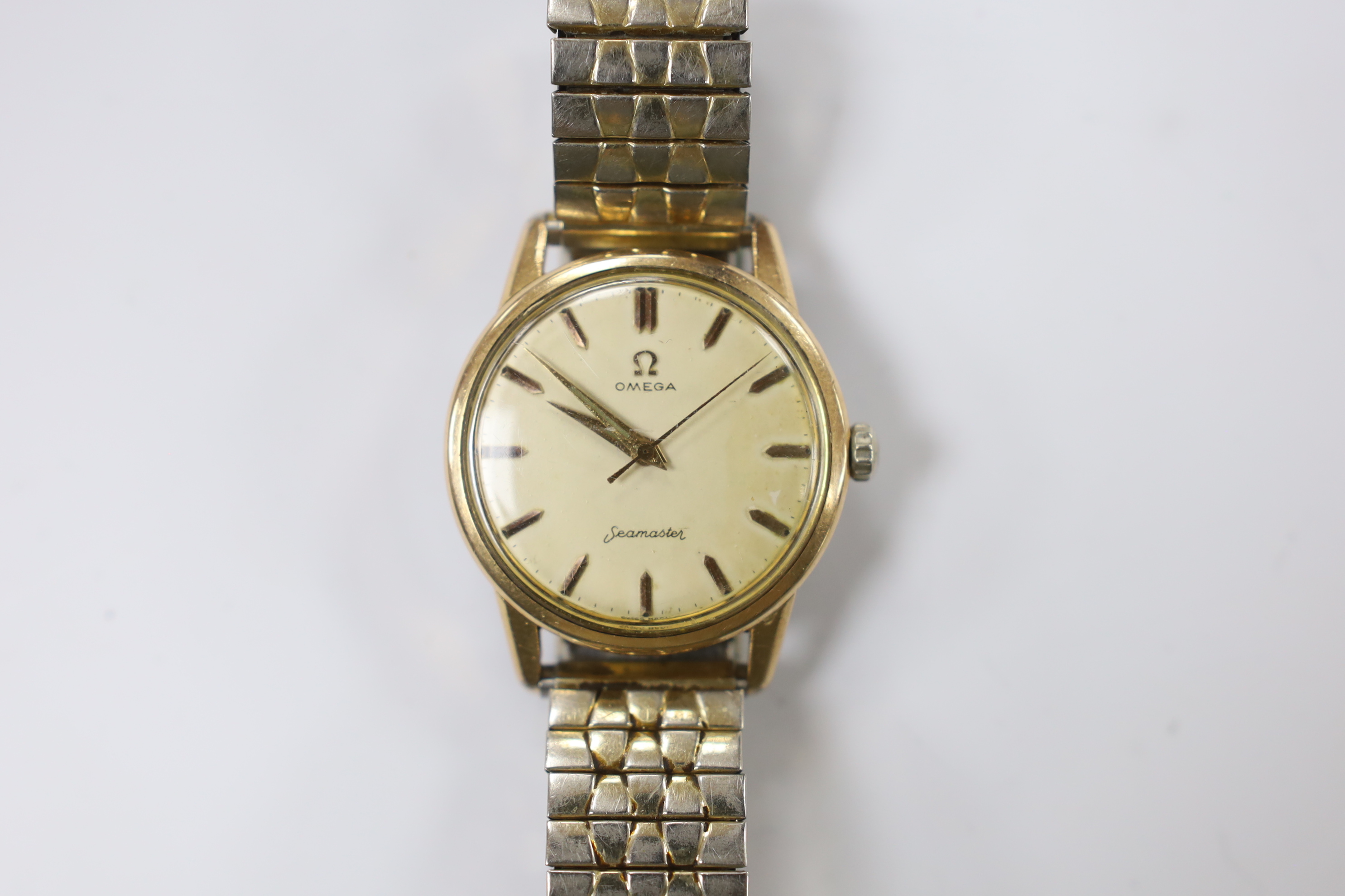 A gentleman's steel and gold plated Omega Seamaster manual wind wrist watch, cased diameter 35mm, on a later associated flexible bracelet.                                                                                  