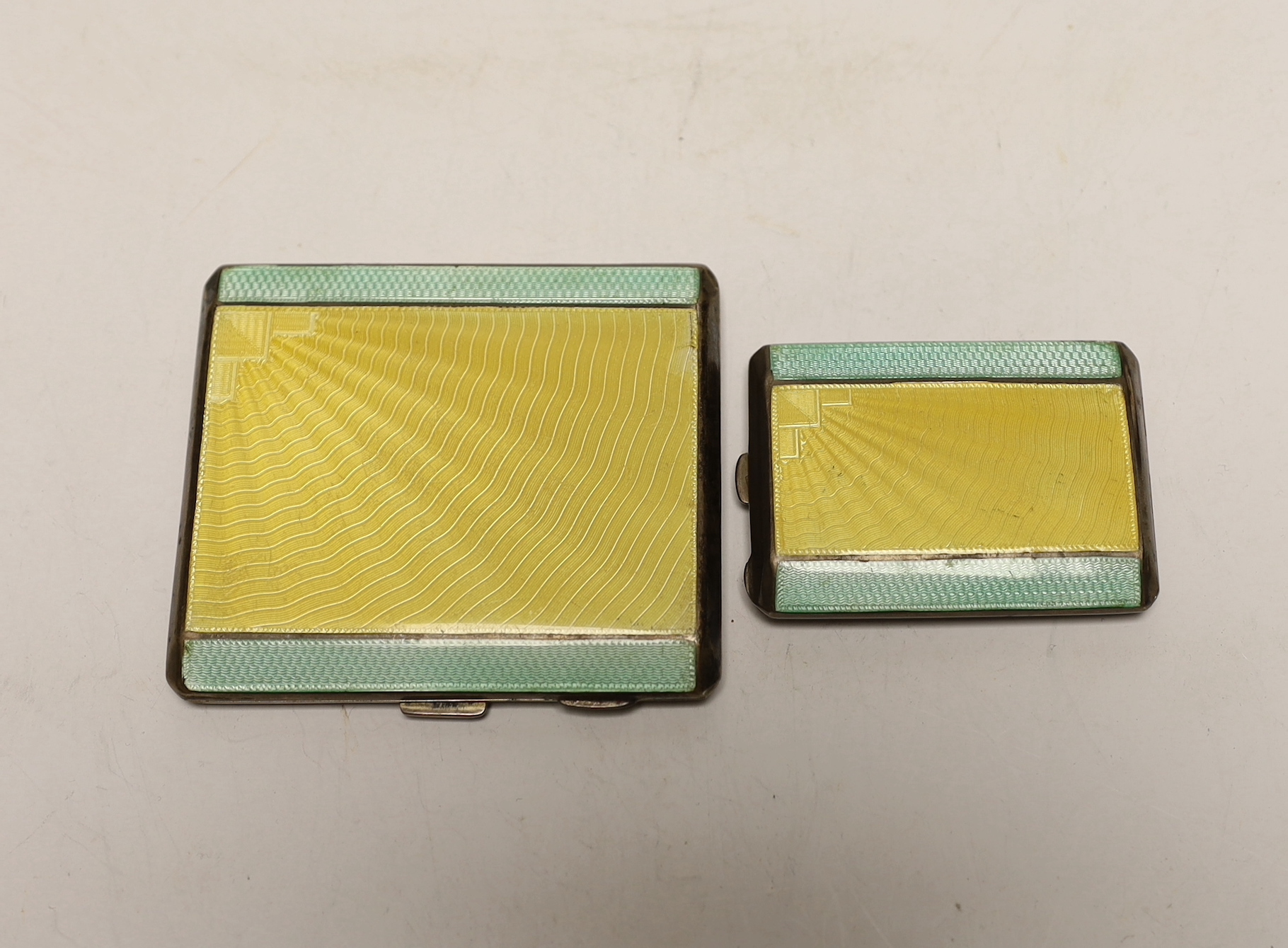 A 1930's Art Deco silver and two colour enamelled cigarette case, William Neale Ltd, Birmingham, 1934, 83mm and a matching match case, Birmingham, 1933.                                                                    