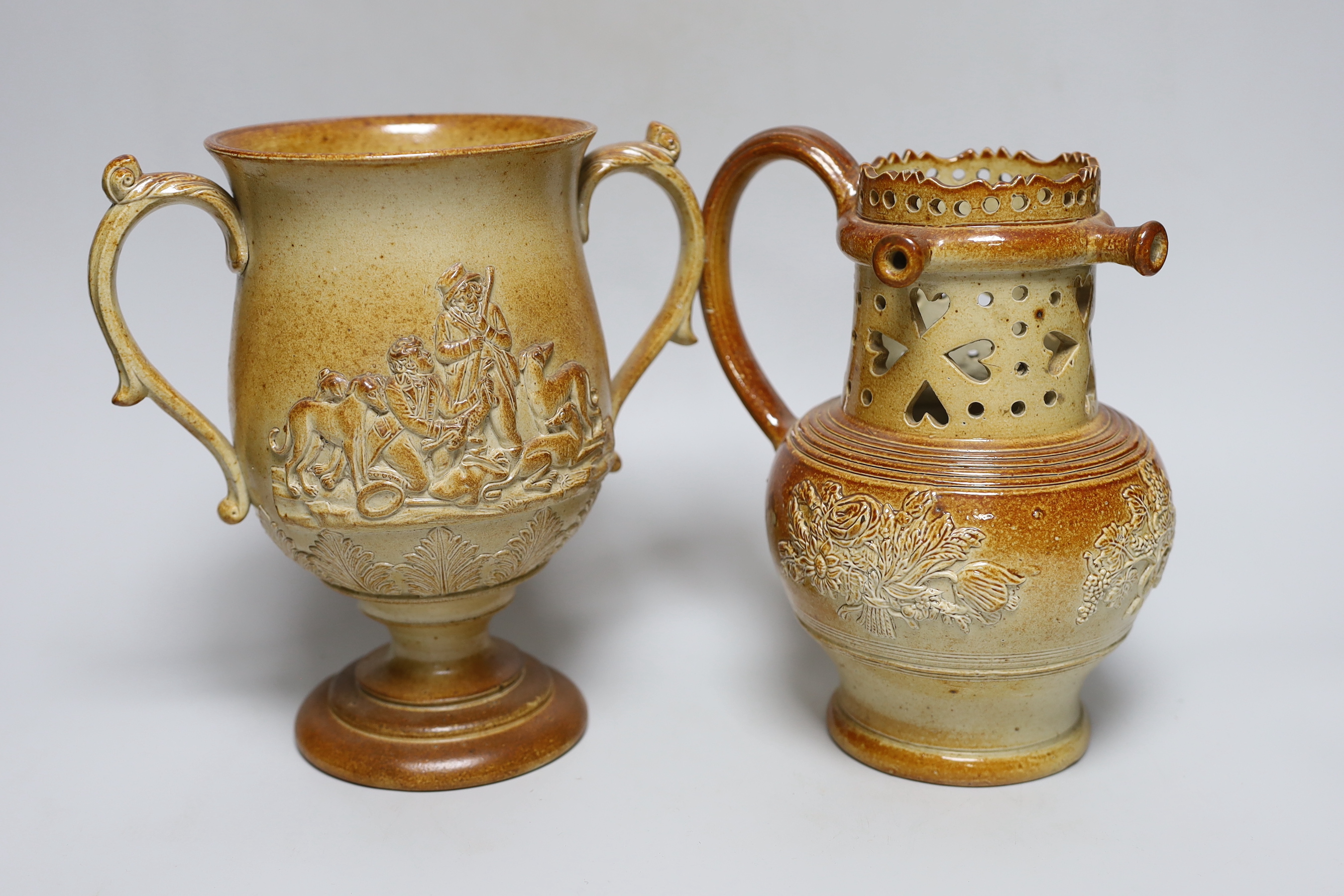 A Brampton salt glazed stoneware puzzle jug and a similar two handled loving cup, c.1840, tallest 21cm                                                                                                                      