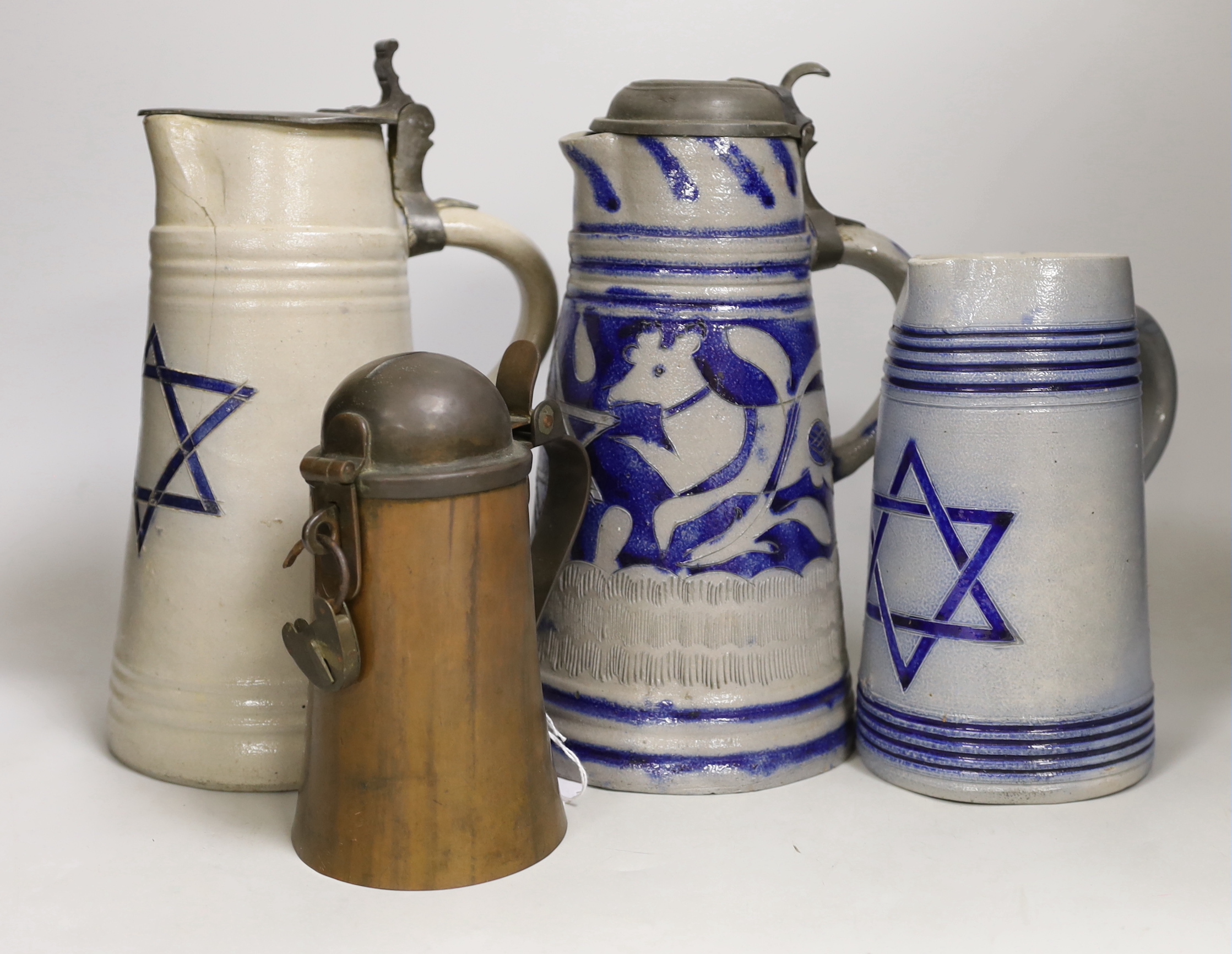 Judaica - three German blue stoneware ‘Star of David’ jugs or steins, and a copper and pewter Tzedakah box, tallest 27cm                                                                                                    