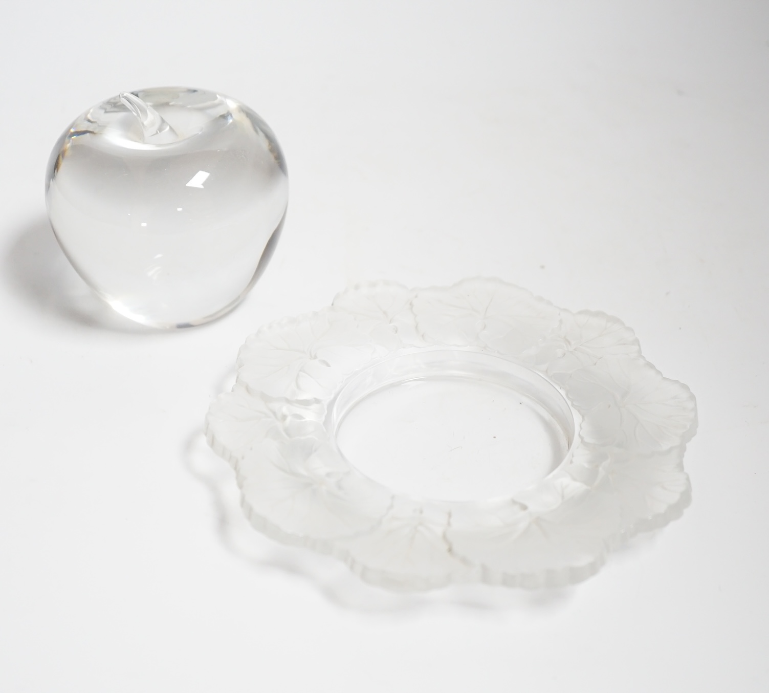 A small Lalique 'Honfleur' dish with frosted leaf border, diameter 15cm and a Tiffany glass 'Apple' paperweight                                                                                                             