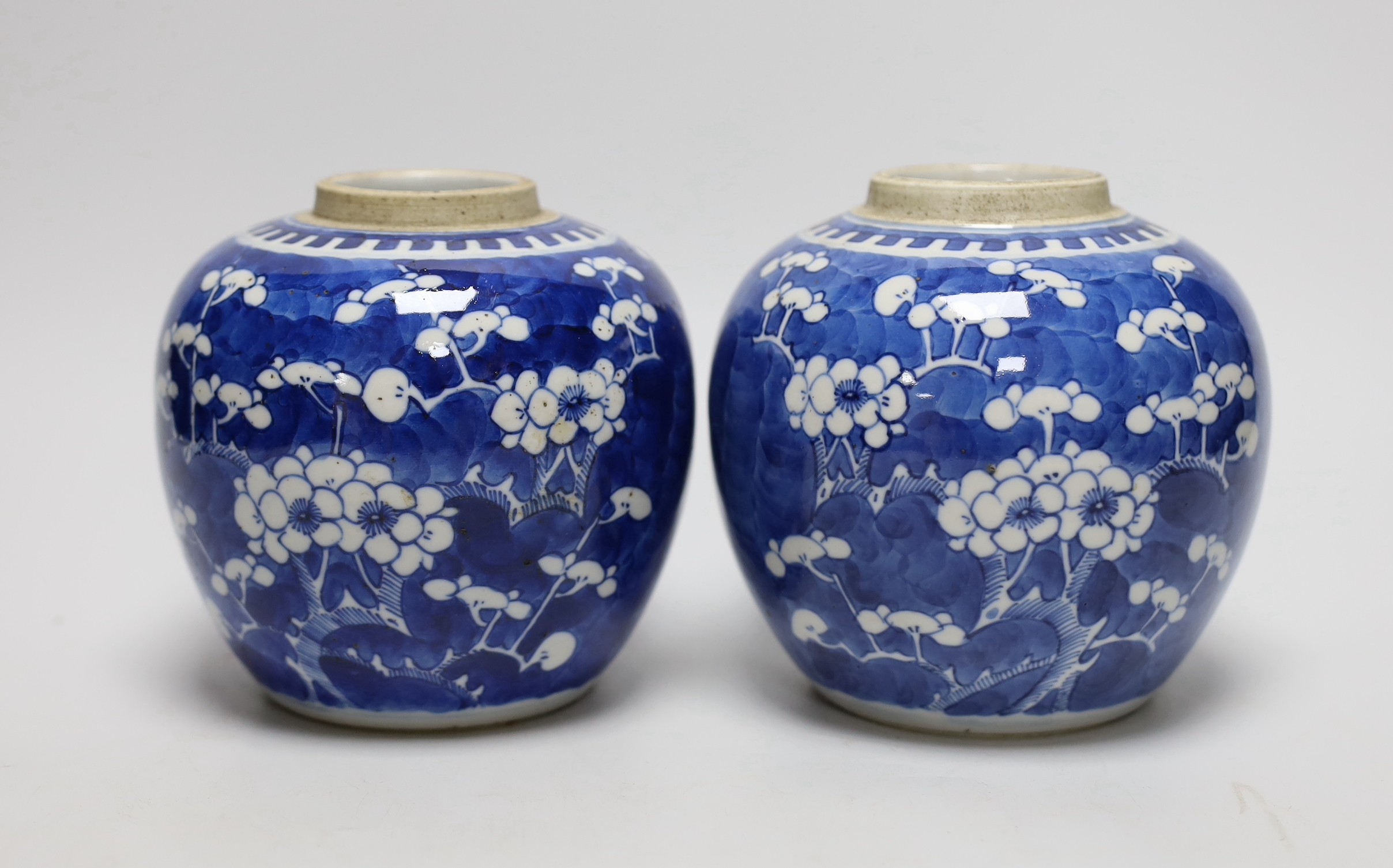 A pair of 19th centiury Chinese blue and white prunus jars, 13.5cms high                                                                                                                                                    