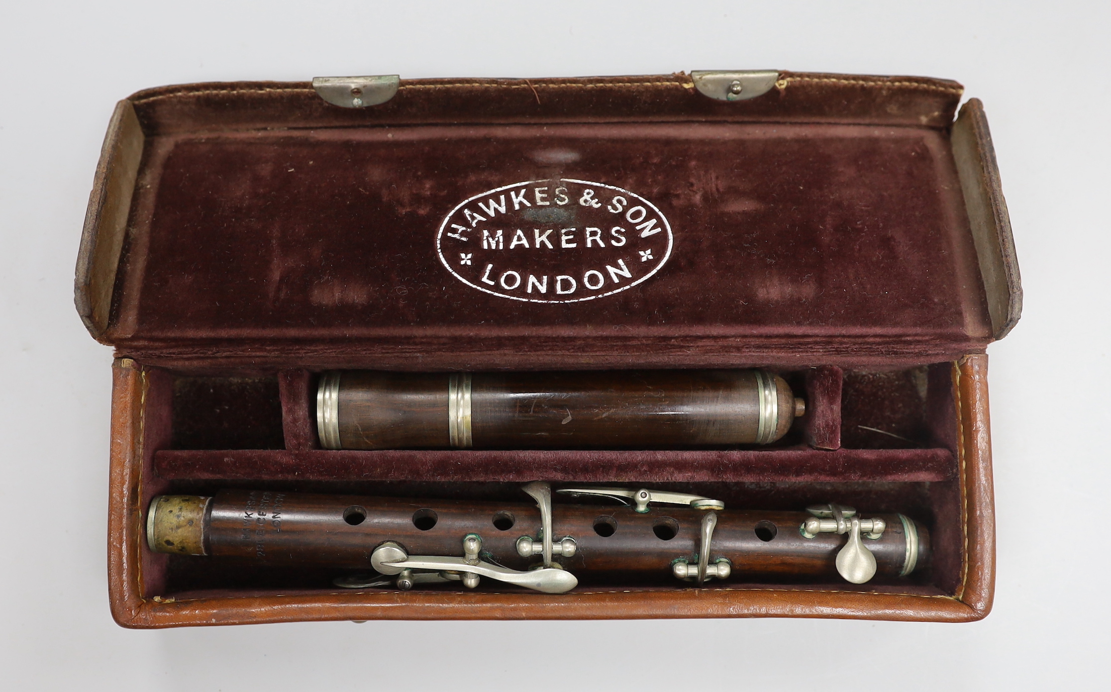 A late Victorian rosewood flute, by Hawkes & Son, leather case                                                                                                                                                              