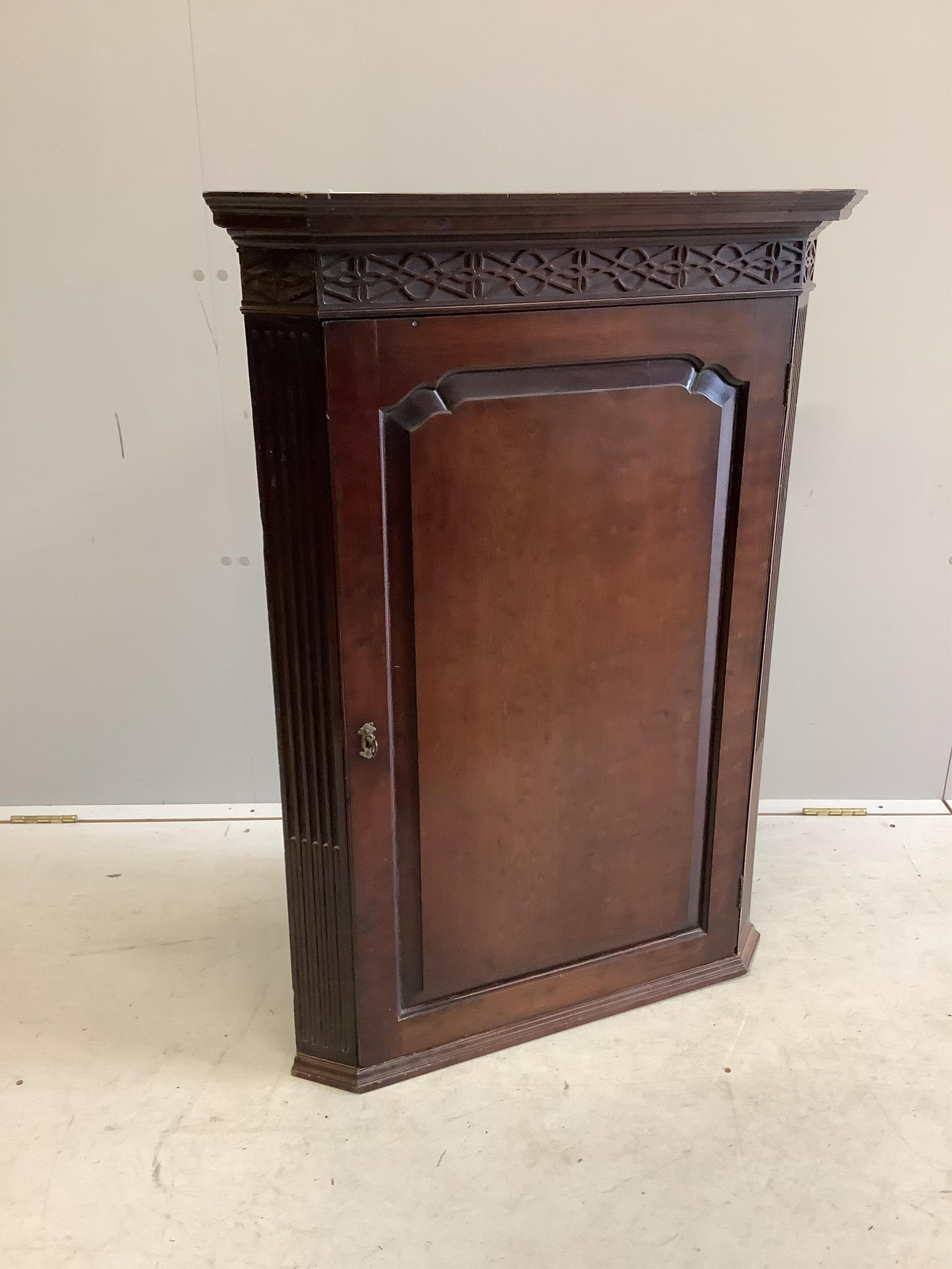 A George III Chippendale style mahogany hanging corner cabinet, width 75cm, depth 41cm, height 102cm. Condition - fair to good                                                                                              