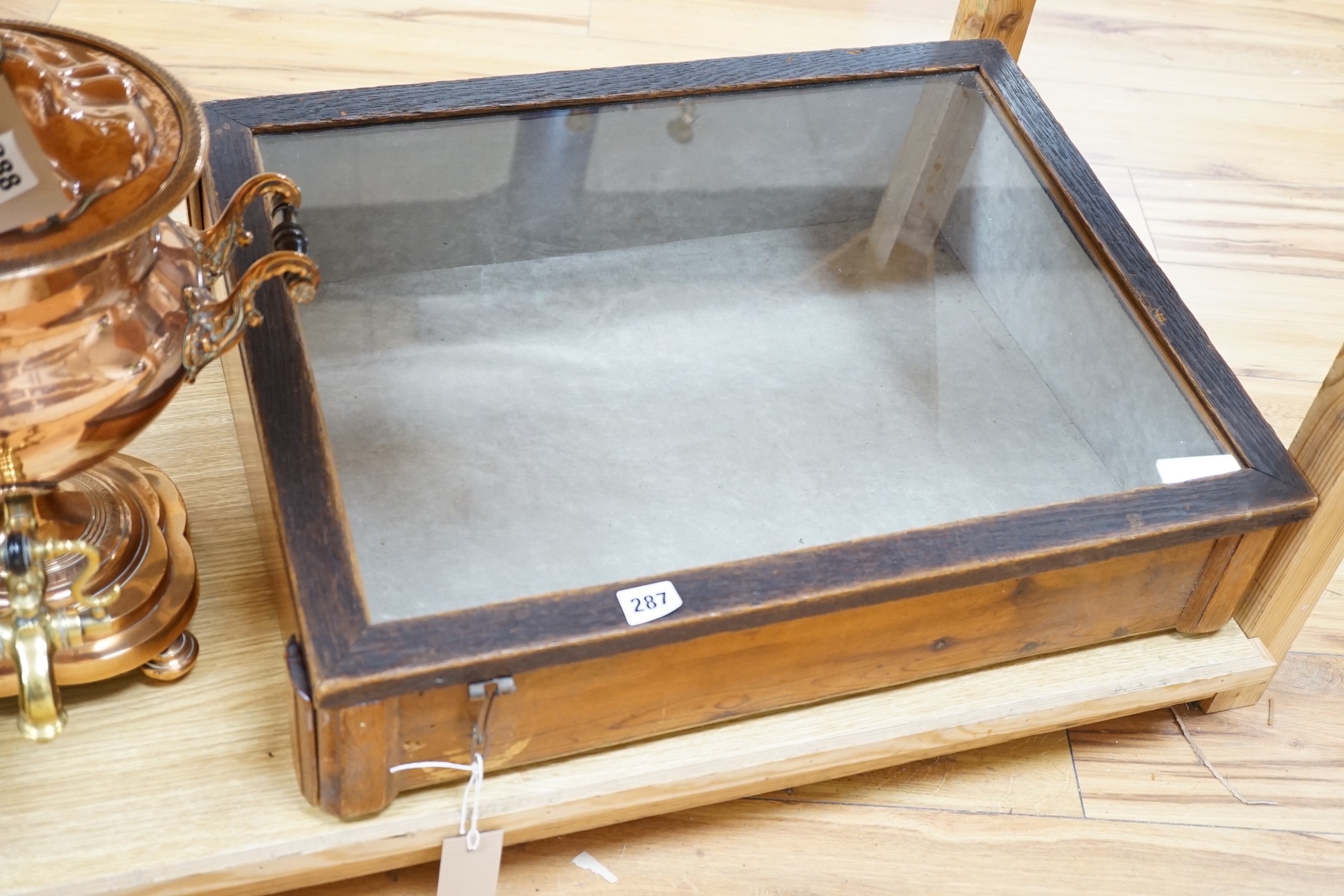 A wooden glazed display case, 62 cm wide                                                                                                                                                                                    