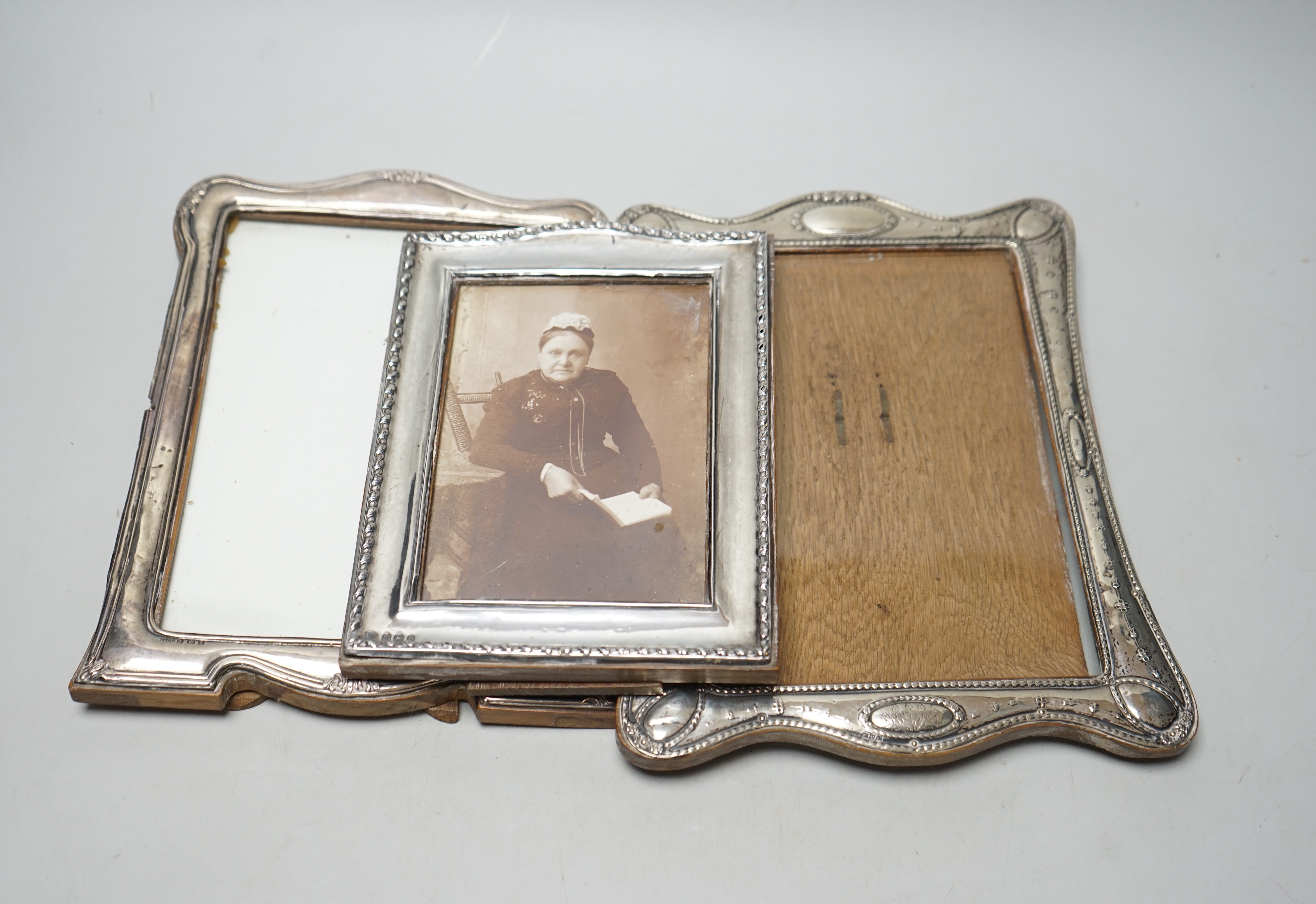 Three assorted George V silver mounted photograph frames, largest 24cm.                                                                                                                                                     