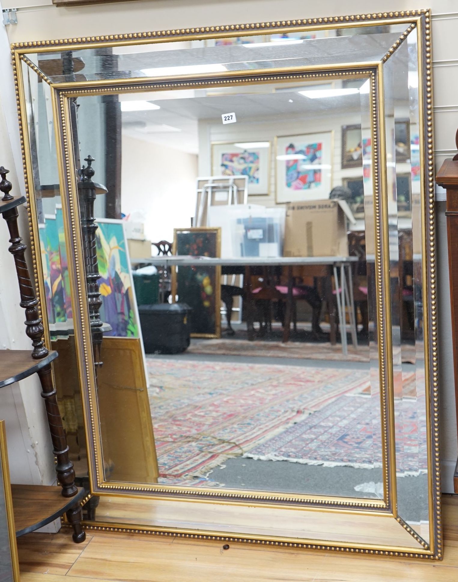 A large bevelled glass wall mirror, width 103cm height 129cm                                                                                                                                                                