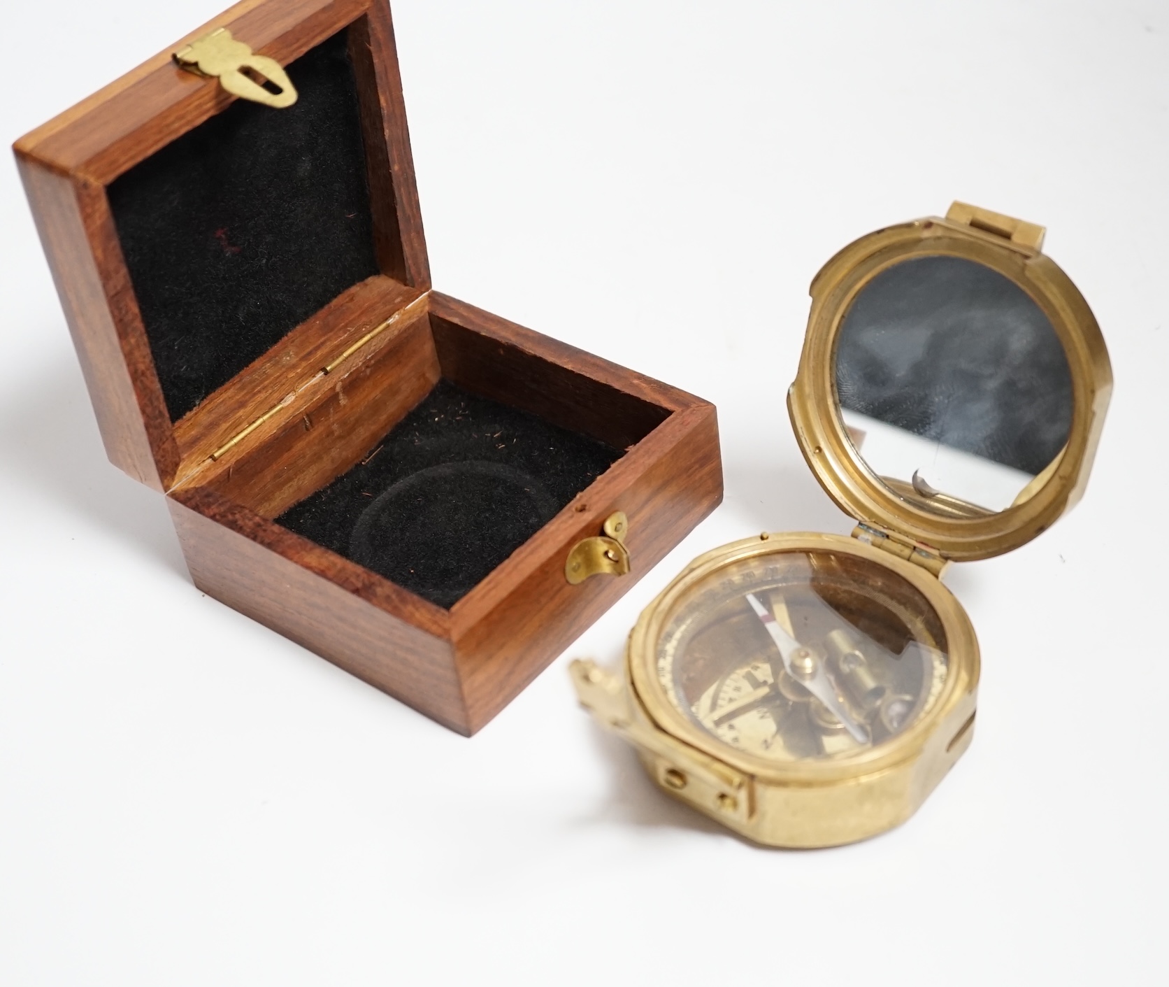 A gilt metal circular pocket barometer by Gallagher and Co., New Bond Street, London (lacks case) and a reproduction solid brass Brunton nautical compass in wooden box                                                     