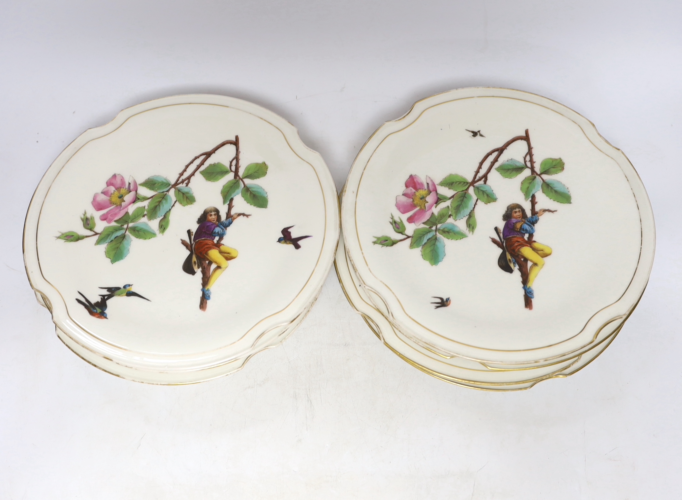 A set of eight late 19th century French Porcelain dessert plates decorated with scenes of figures on branched swings surrounded by flowers, 24cm diameter                                                                   