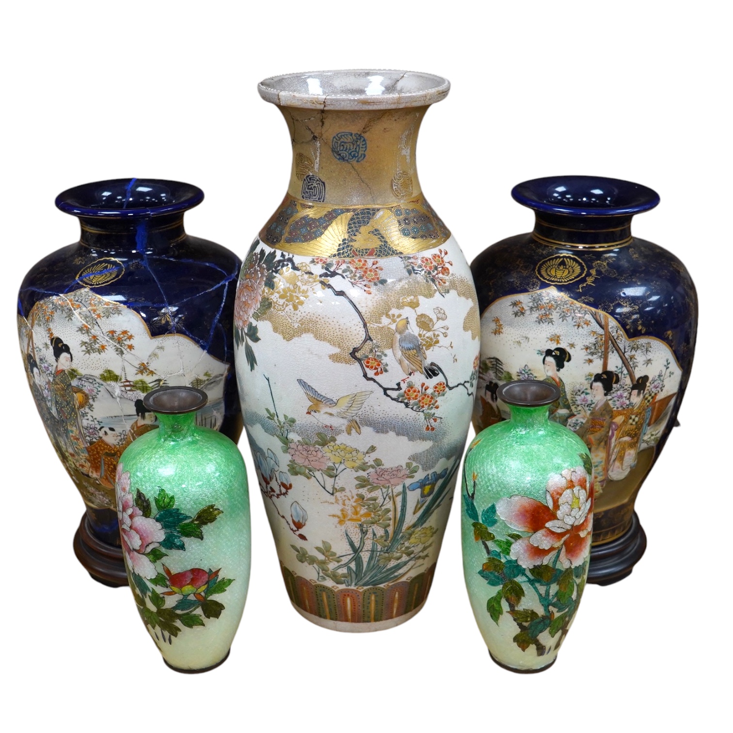 A pair of Japanese Satsuma vases on stands, a pair of floral enamel vases and another Satsuma pottery vase, largest 35cm high. Condition - poor                                                                             