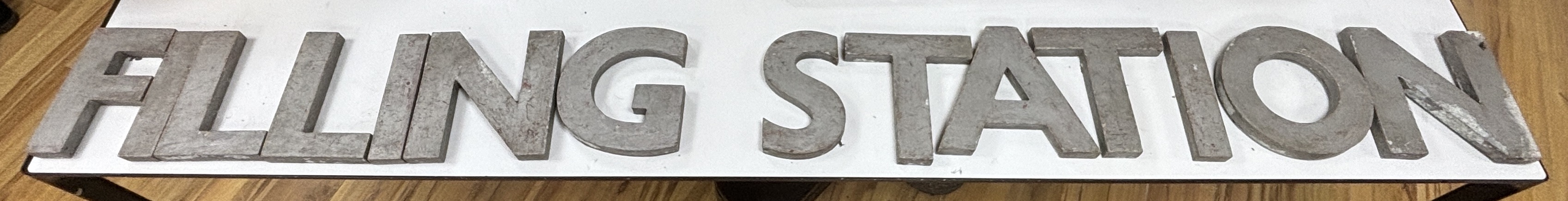 A collection of large metal letters spelling ' Filling Station' letters 23cm high (14)                                                                                                                                      