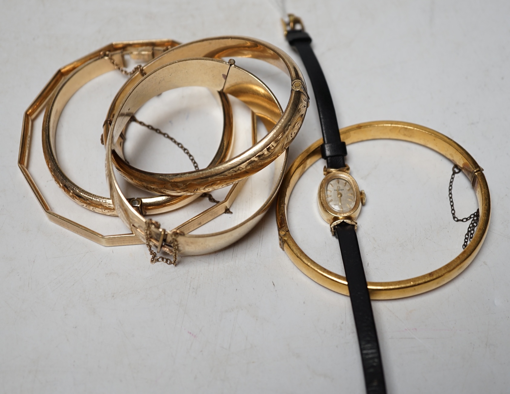 A lady's modern 14k Omega manual wind wrist watch and five assorted metal bangles. Condition - poor to fair                                                                                                                 