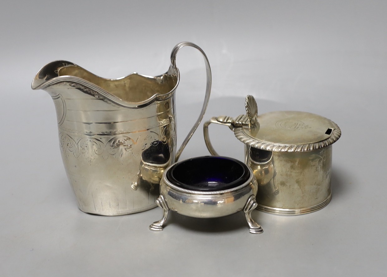 A George III silver cream jug, London, 1794, 10.3cm, a Georgian silver mustard pot and a Georgian silver salt.                                                                                                              