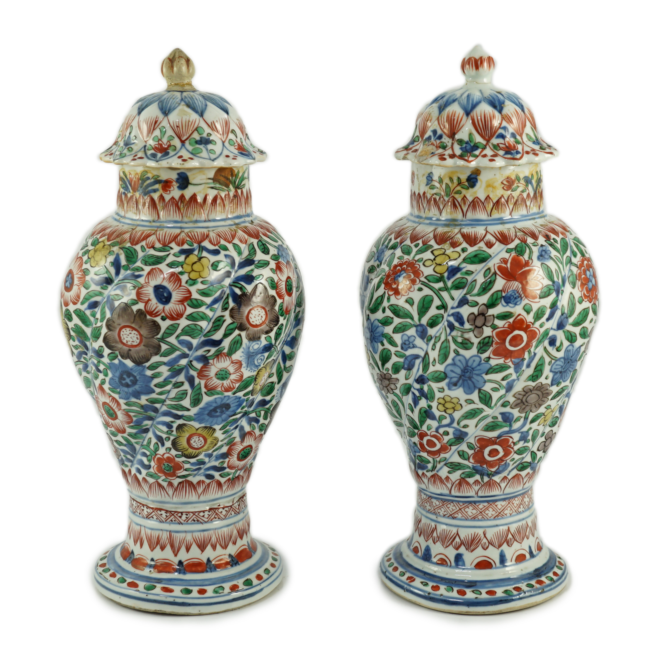 A pair of Chinese wucai spiral lobed baluster vases and covers, Kangxi, c.1680                                                                                                                                              