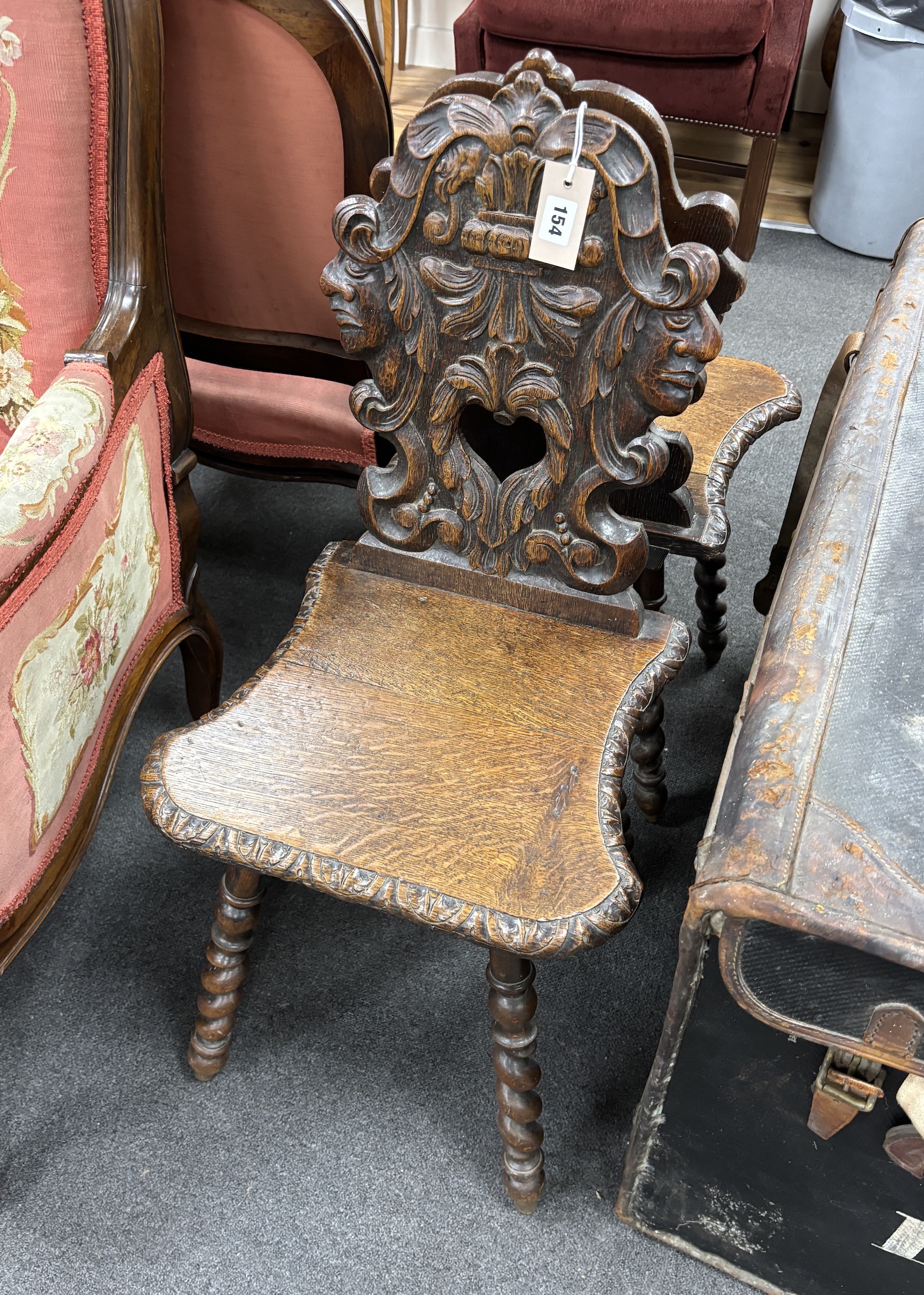 A pair of 19th century Flemish carved oak hall chairs, width 42cm, depth 36cm, height 88cm                                                                                                                                  