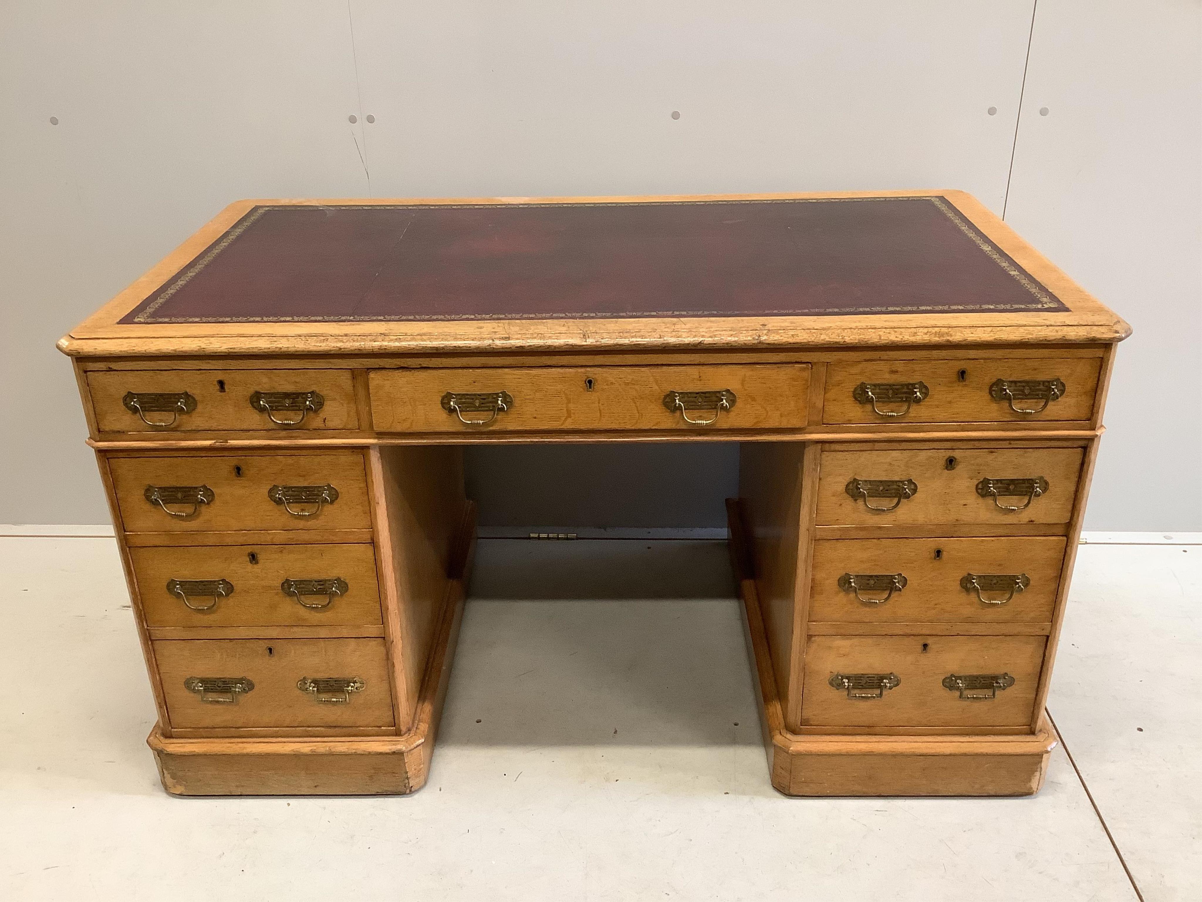 A Victorian golden oak pedestal desk, stamped E Buckham, width 136cm, depth 74cm, height 76cm. Condition - fair to good                                                                                                     