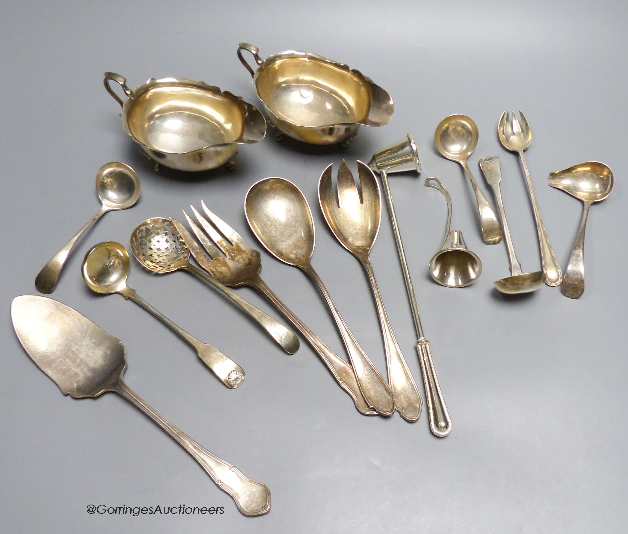 A pair of oval silver sauce boats, a pair of Scottish George III silver sauce ladles, another pair of silver sauce ladles, a Georgian silver sifter spoon, a 925 candle snuffer and sundries, approximately17.5oz           